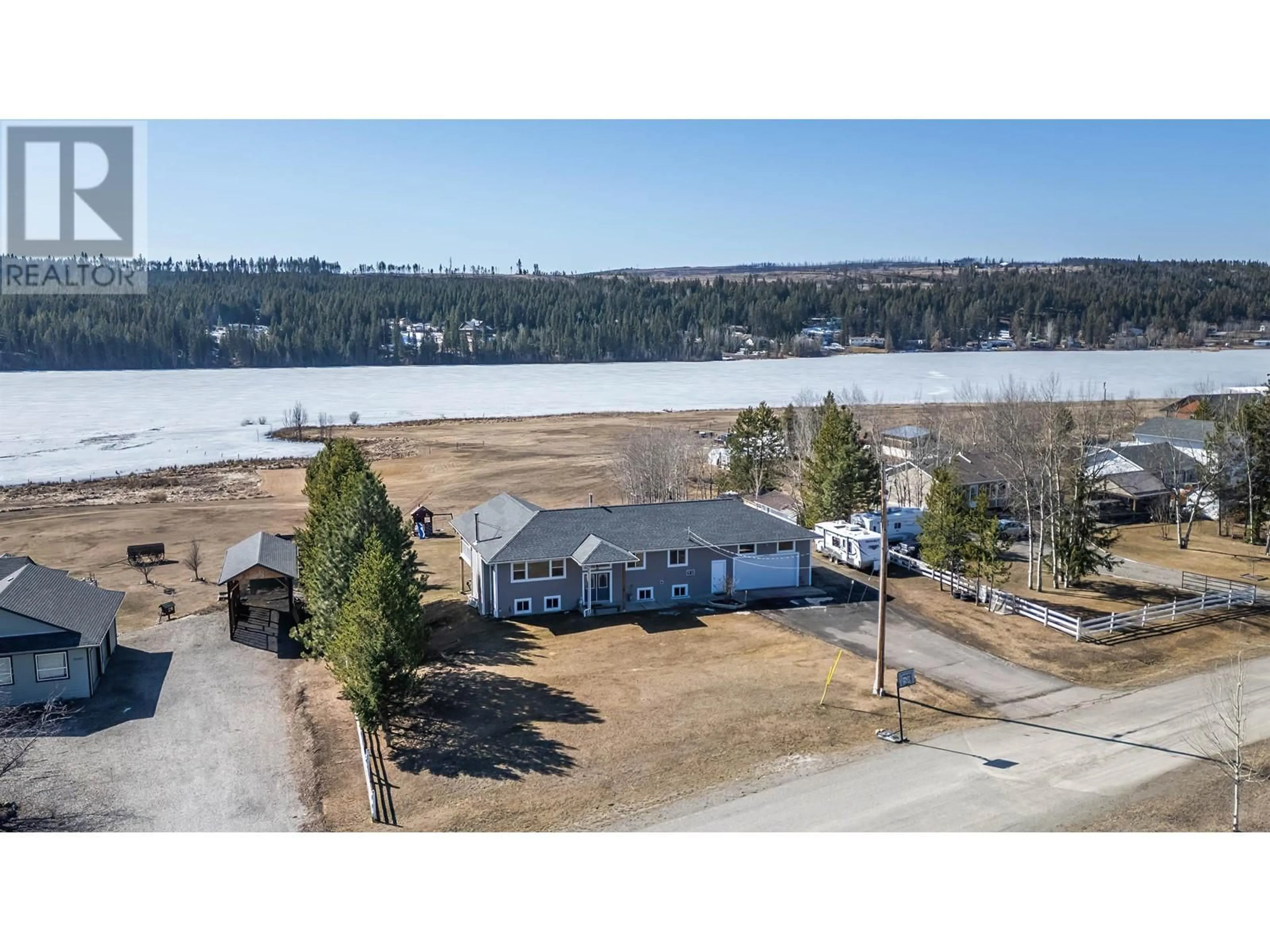A pic from outside/outdoor area/front of a property/back of a property/a pic from drone, water/lake/river/ocean view for 5588 LAKESIDE COURT, 103 Mile House British Columbia V0K2E1