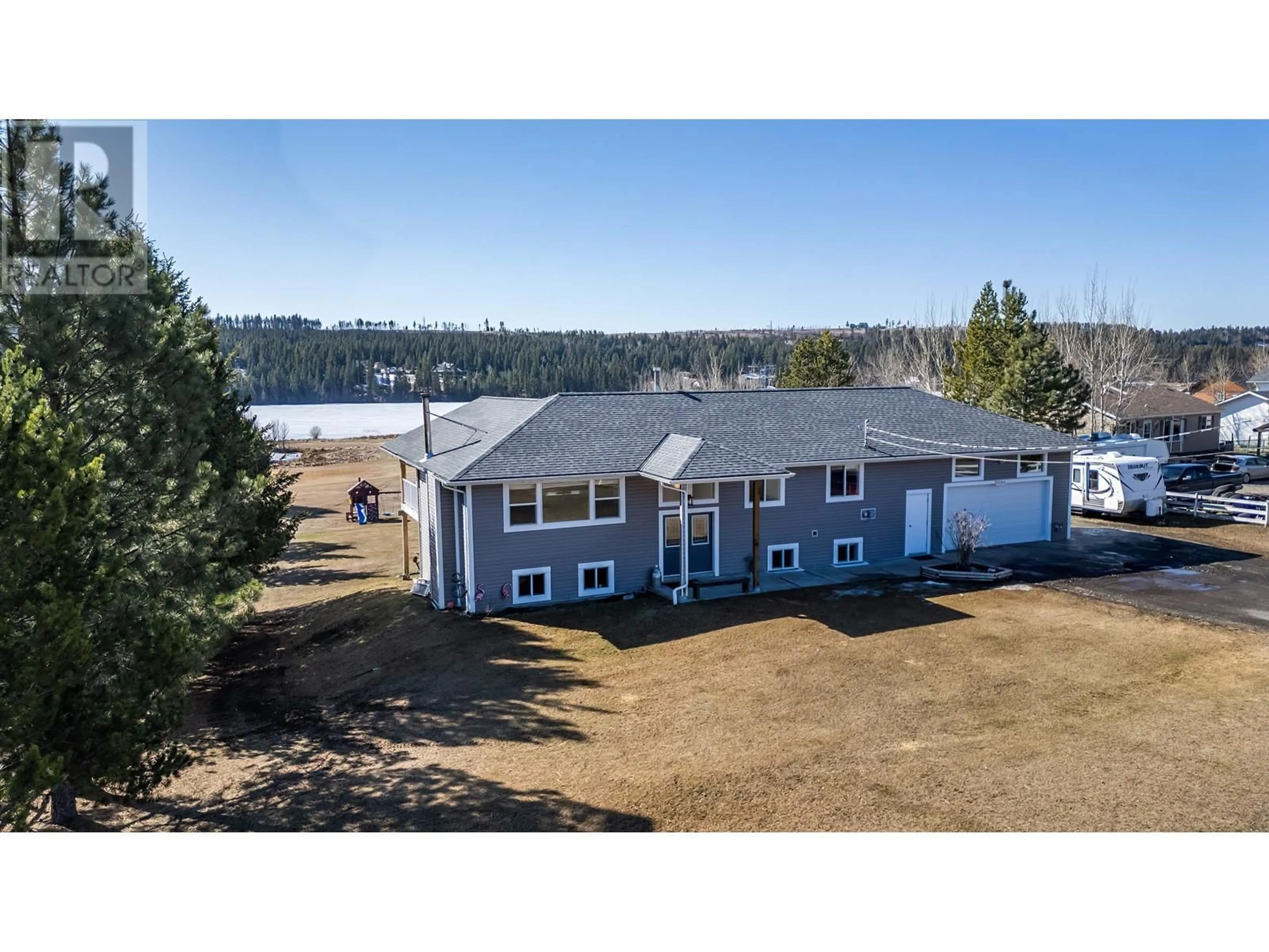 A pic from outside/outdoor area/front of a property/back of a property/a pic from drone, water/lake/river/ocean view for 5588 LAKESIDE COURT, 103 Mile House British Columbia V0K2E1