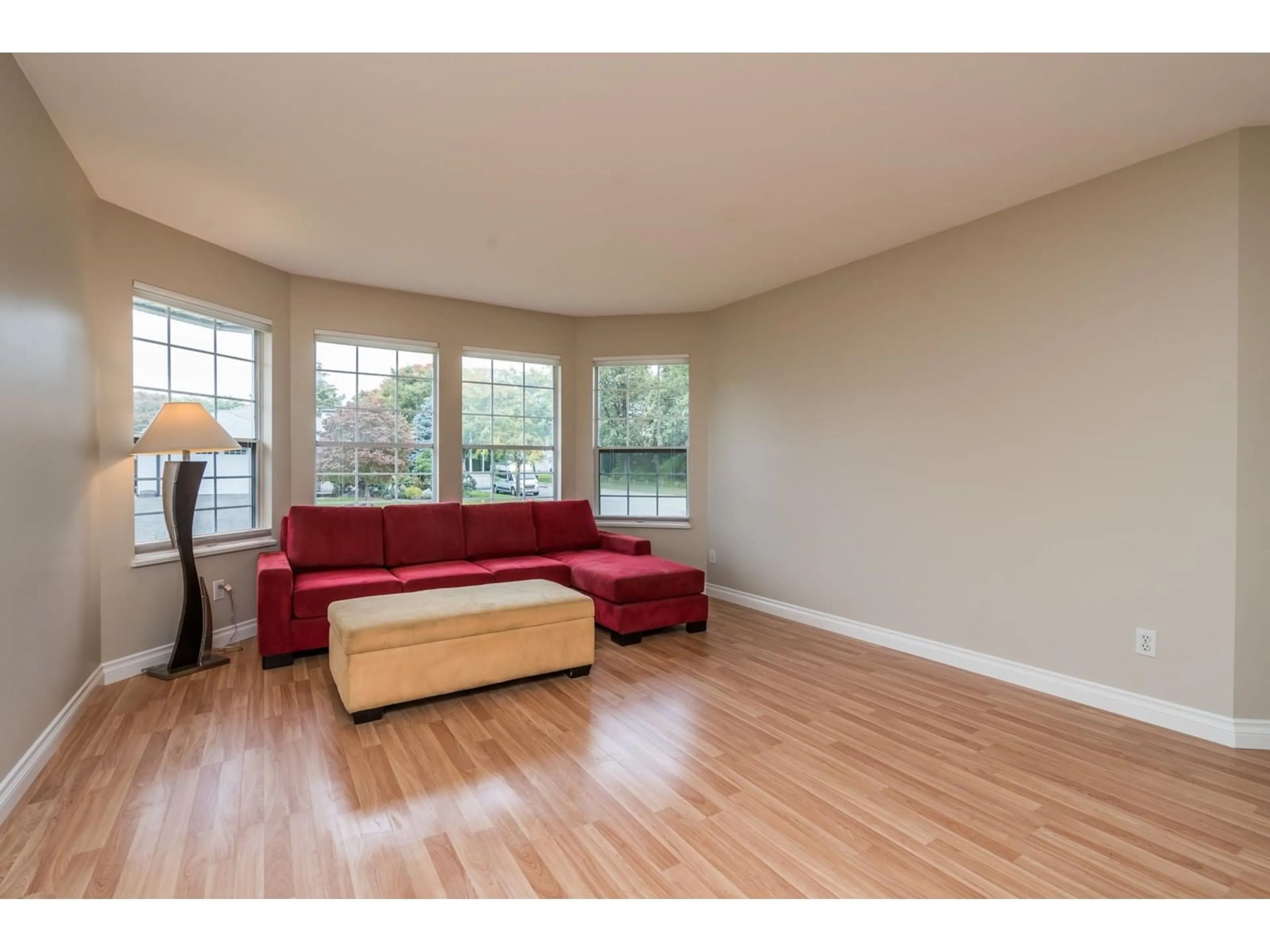 Living room with furniture, wood/laminate floor for 18890 61A AVENUE, Surrey British Columbia V3S7T6