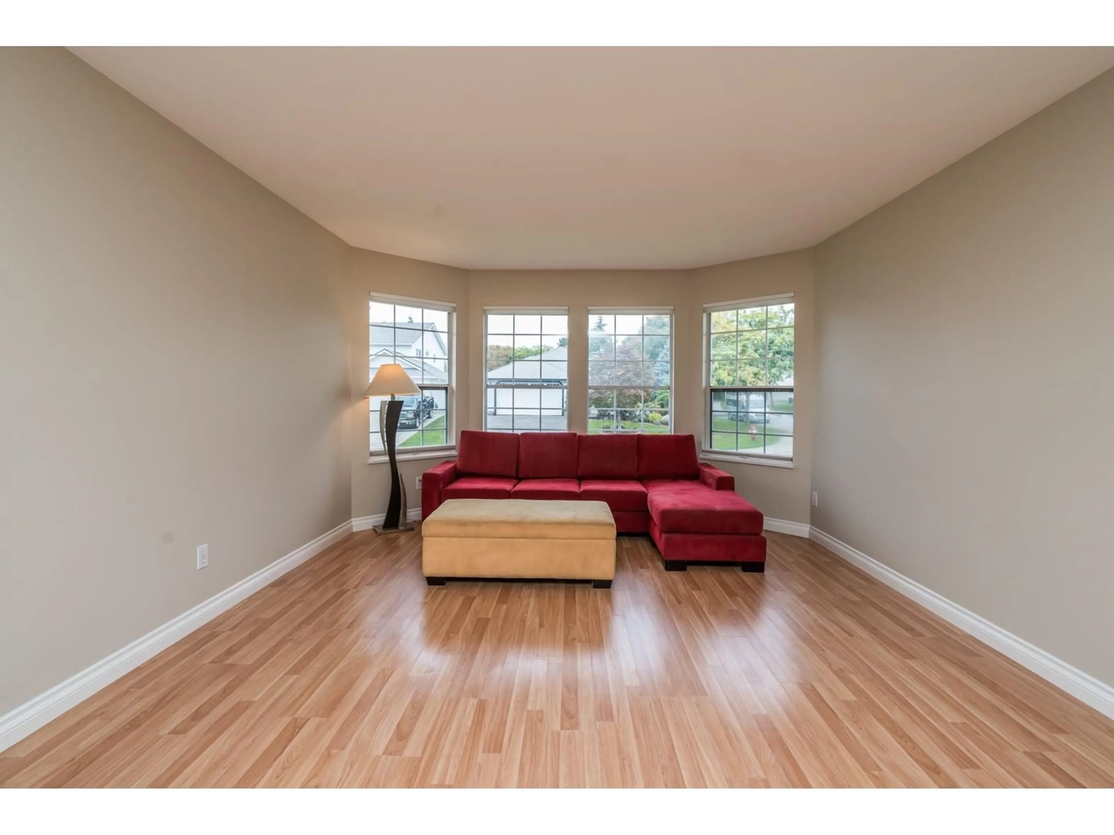 Living room with furniture, wood/laminate floor for 18890 61A AVENUE, Surrey British Columbia V3S7T6