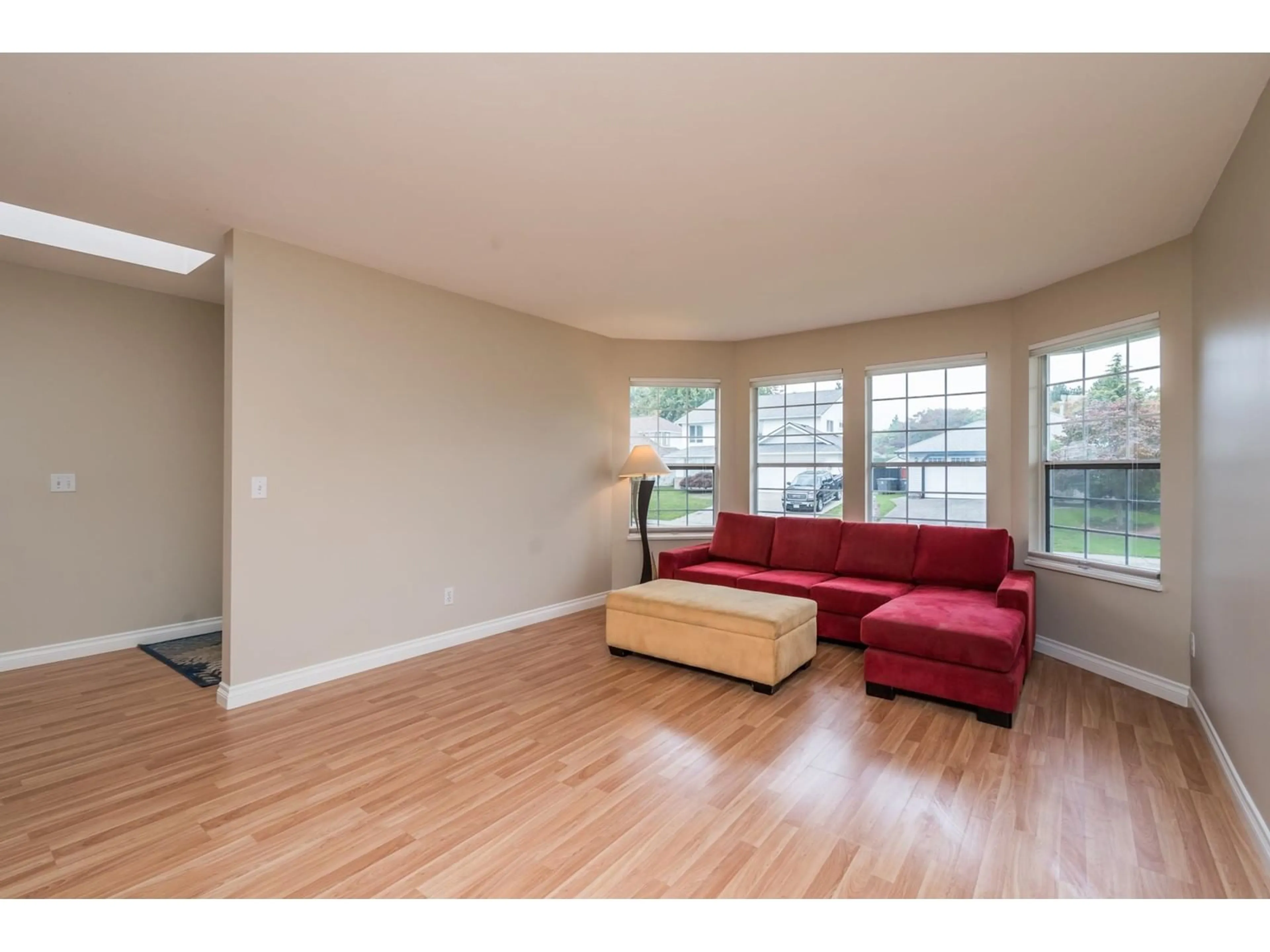 Living room with furniture, wood/laminate floor for 18890 61A AVENUE, Surrey British Columbia V3S7T6