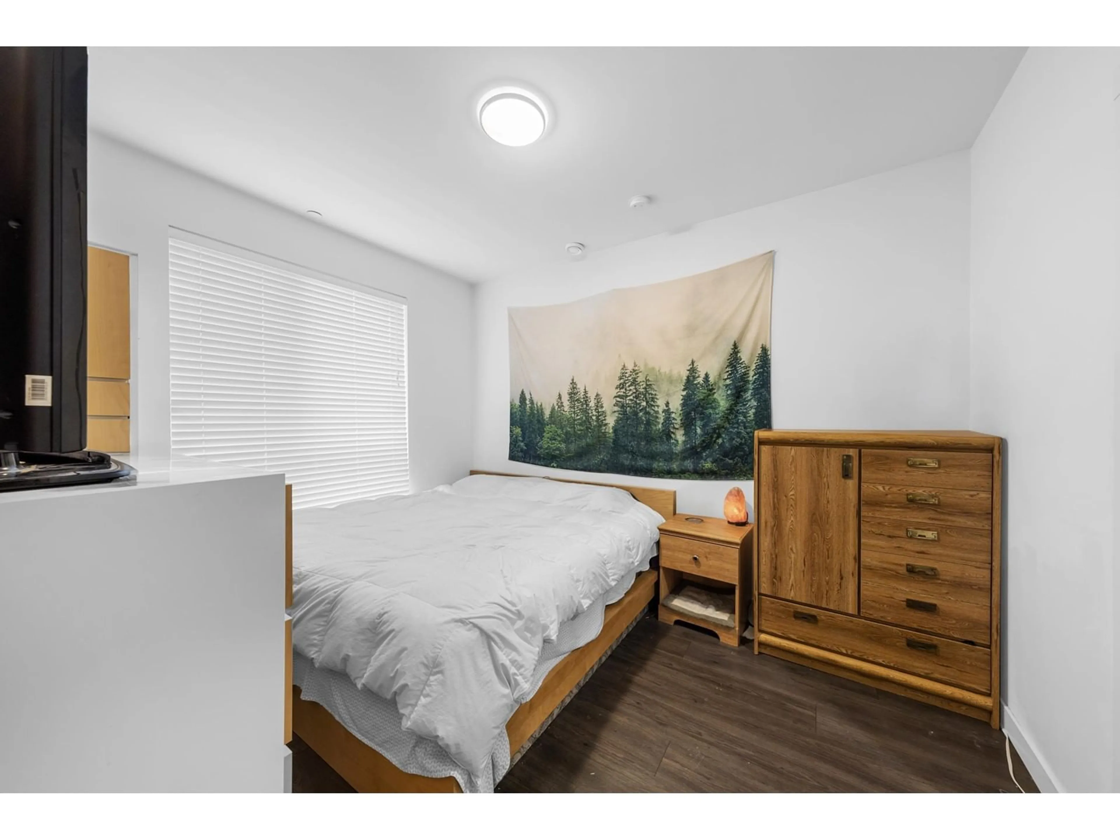 Bedroom with bed, wood/laminate floor for 107 33540 MAYFAIR AVENUE, Abbotsford British Columbia V2S0J3