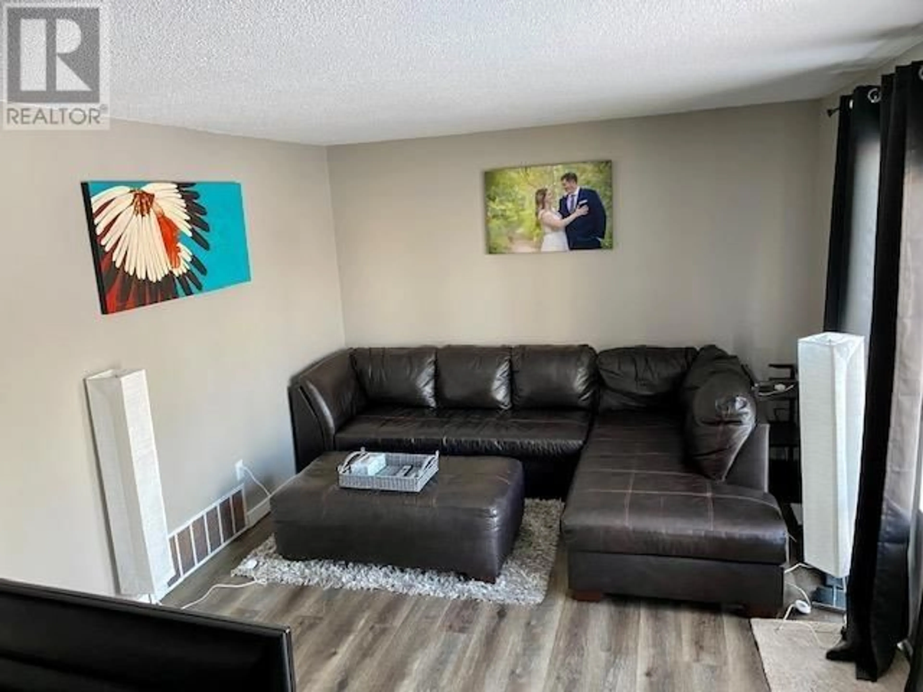 Living room with furniture, wood/laminate floor for 14 - 5320 MOUNTAINVIEW DRIVE, Fort Nelson British Columbia V0C1R0