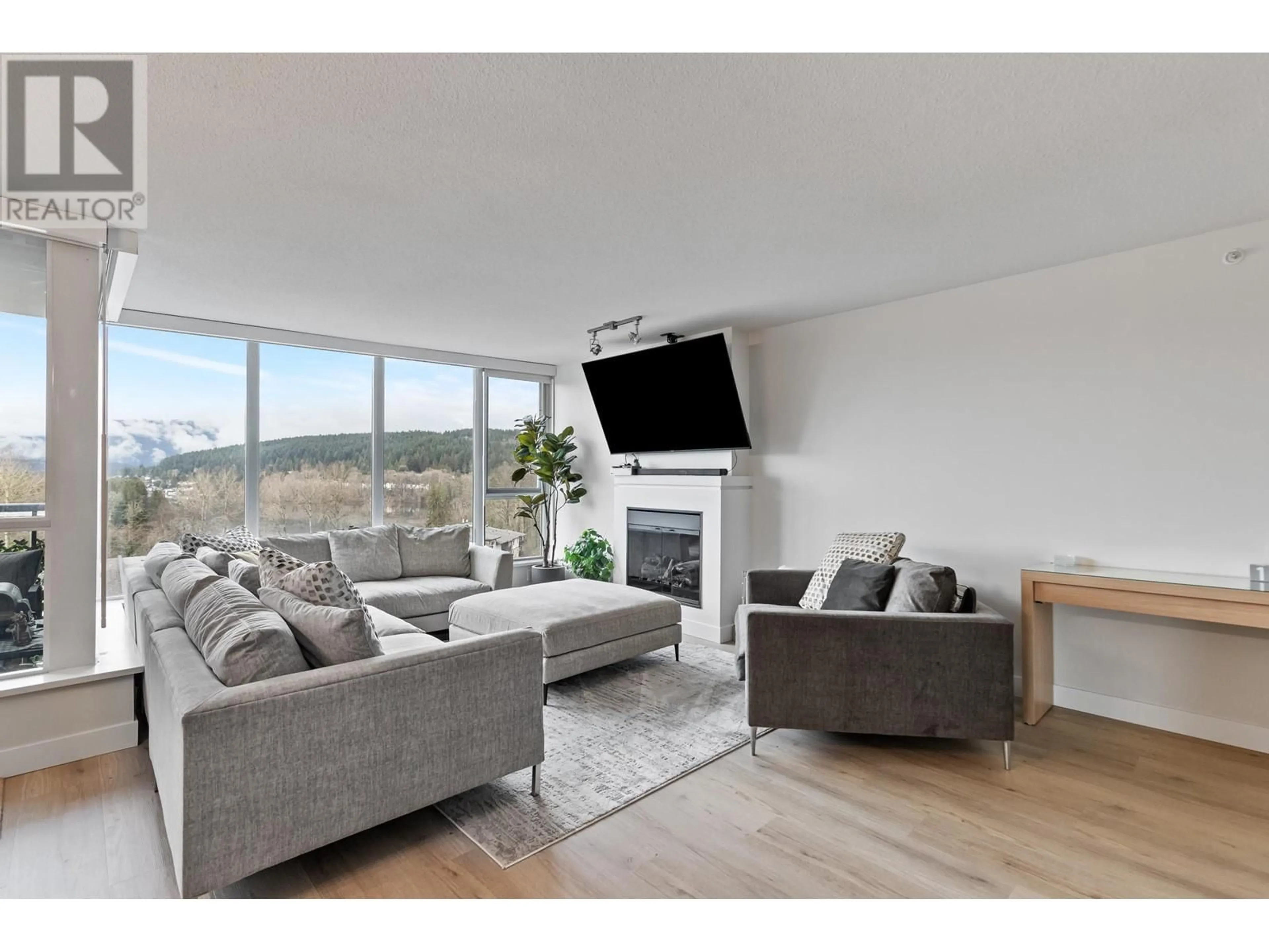 Living room with furniture, wood/laminate floor for 1103 660 NOOTKA WAY, Port Moody British Columbia V3H0B7