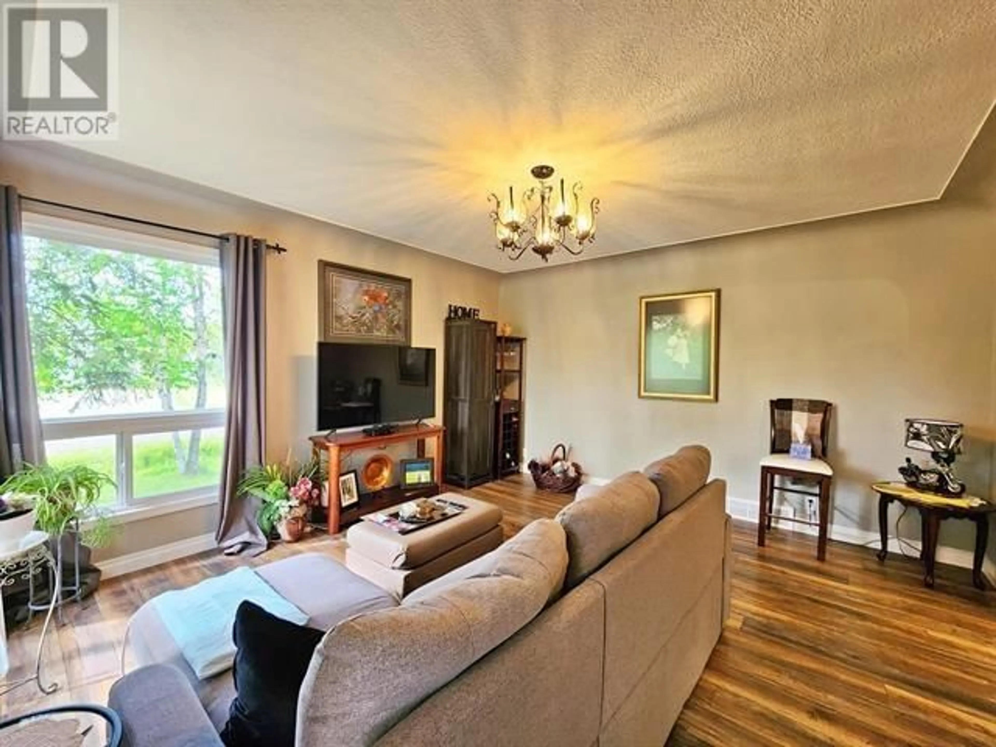 Living room with furniture, wood/laminate floor for 2290 ASH AVENUE, Quesnel British Columbia V2J3X7