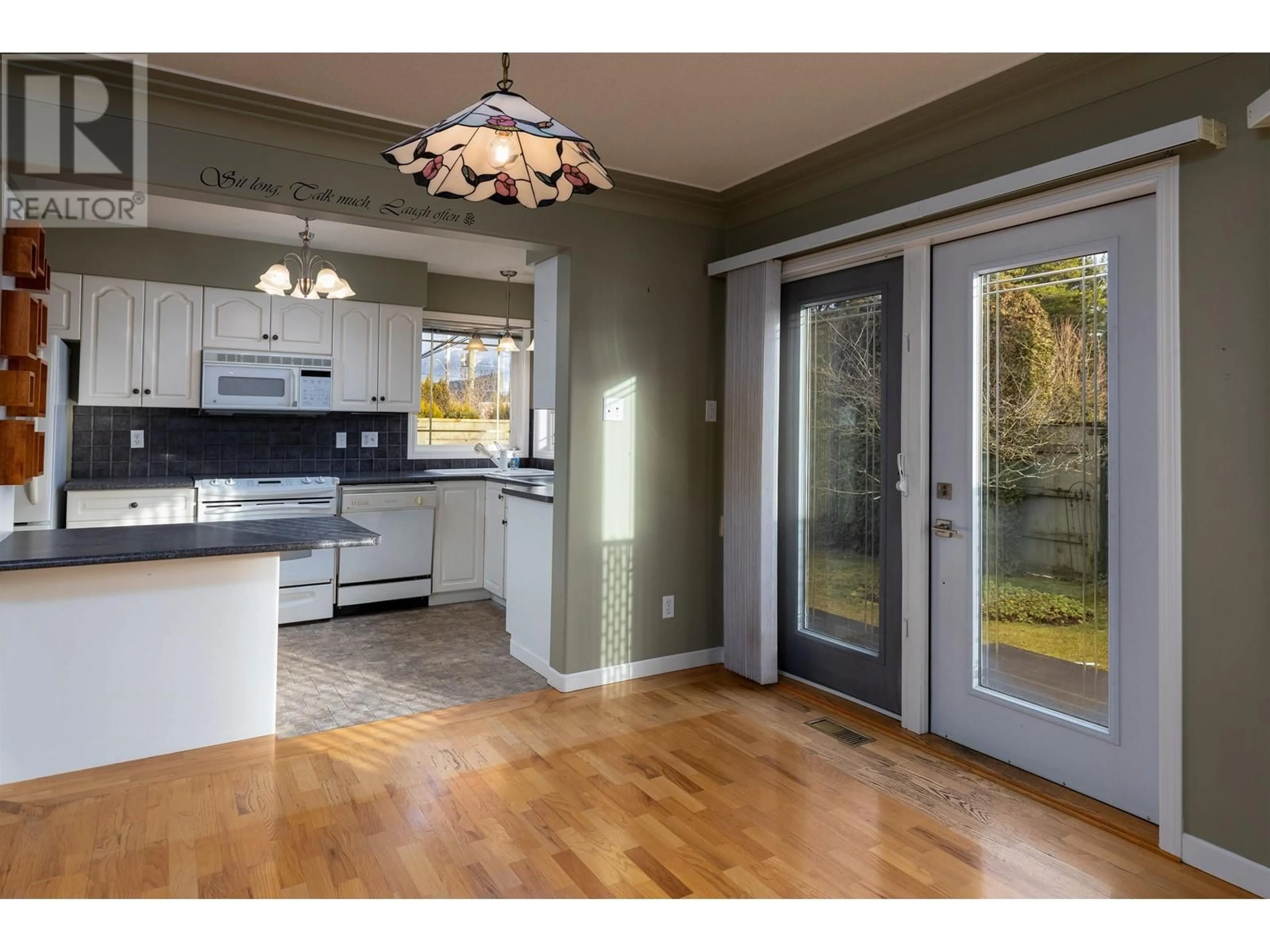 Open concept kitchen, wood/laminate floor for 1 3215 KENNEY STREET, Terrace British Columbia V8G3E9