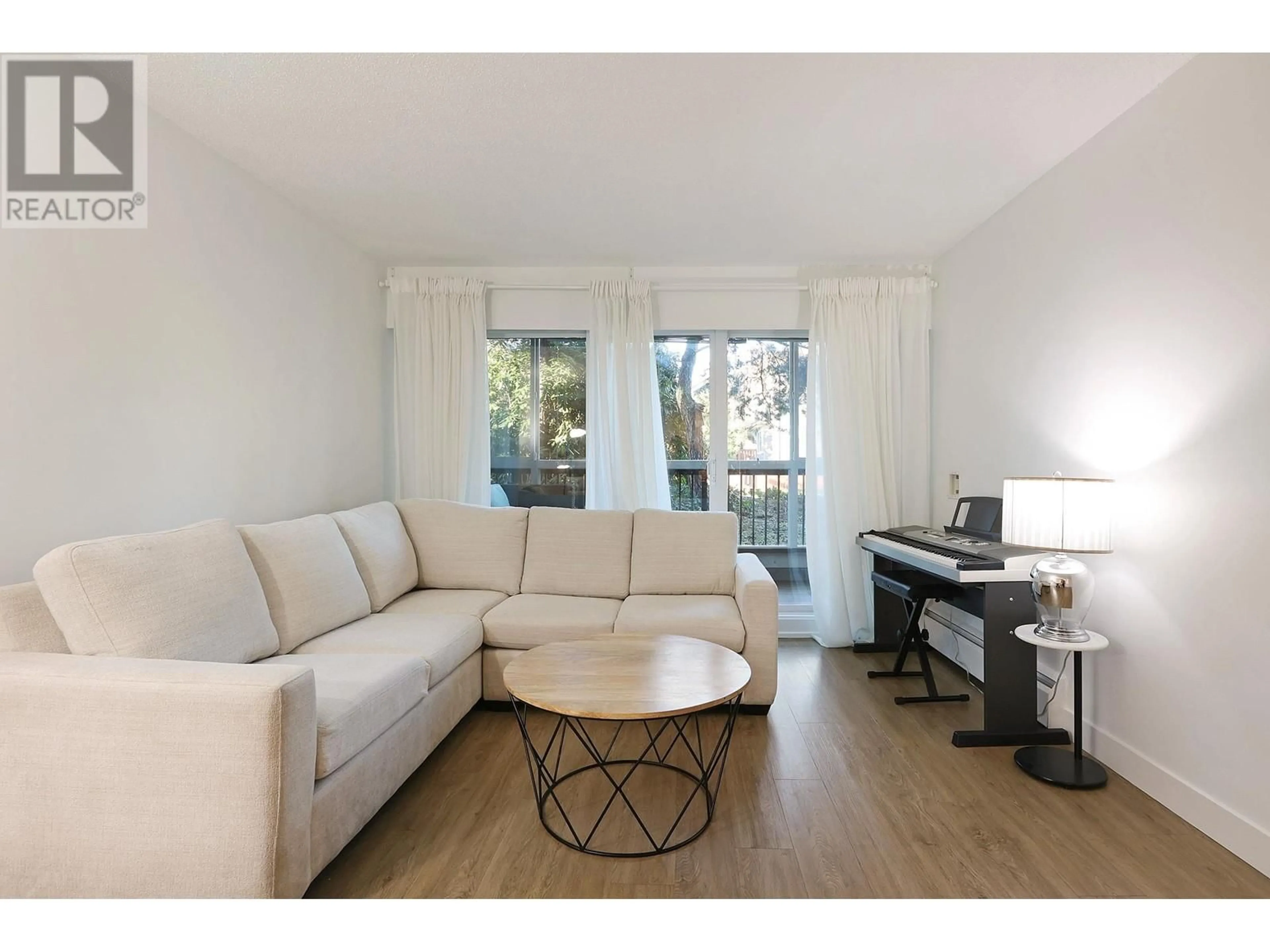 Living room with furniture, wood/laminate floor for 108 2770 BURRARD STREET, Vancouver British Columbia V6J3J8