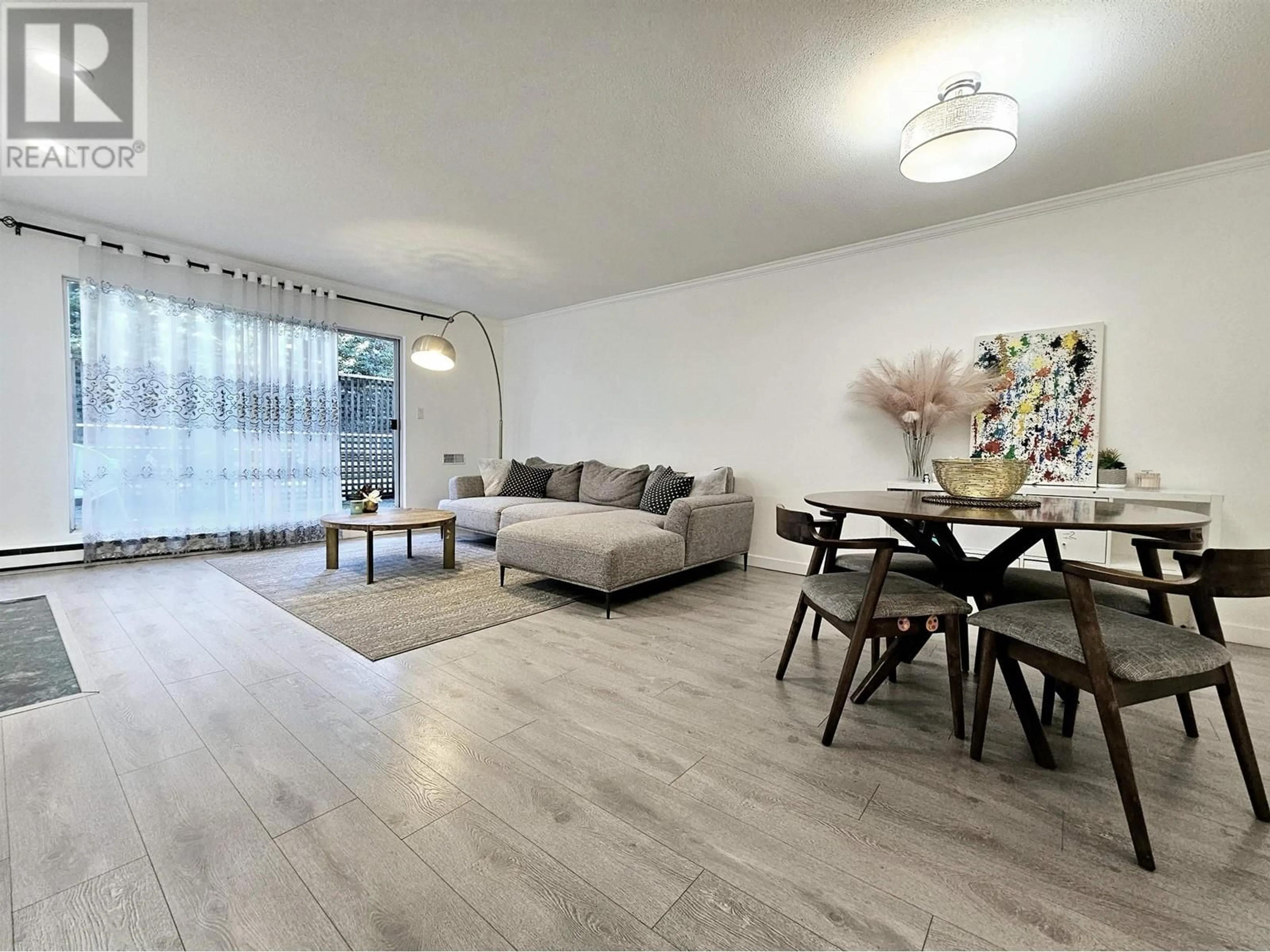 Living room with furniture, wood/laminate floor for 106 8120 BENNETT ROAD, Richmond British Columbia V6Y1N5