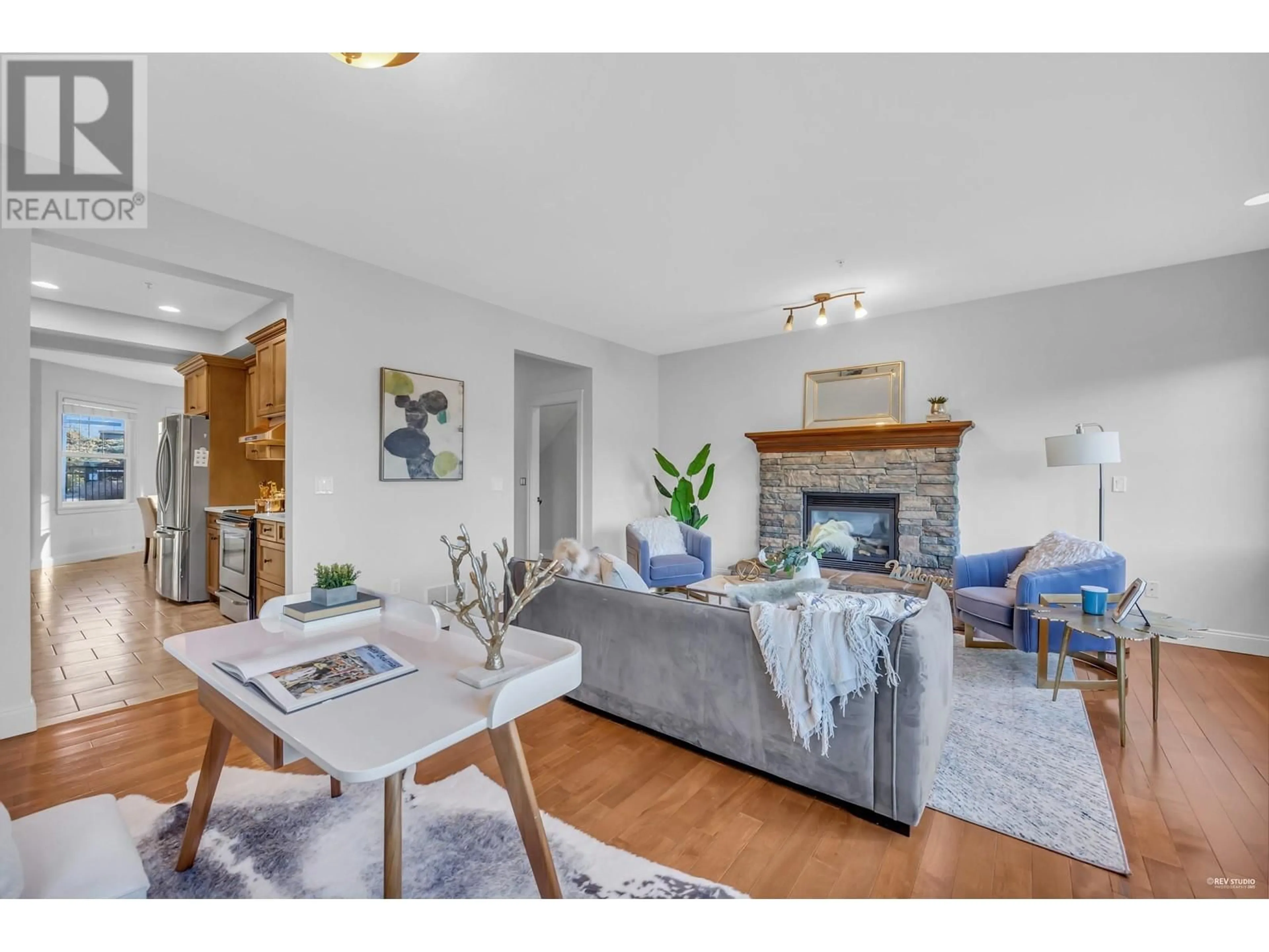 Living room with furniture, wood/laminate floor for 101 23925 116 AVENUE, Maple Ridge British Columbia V2W0C3