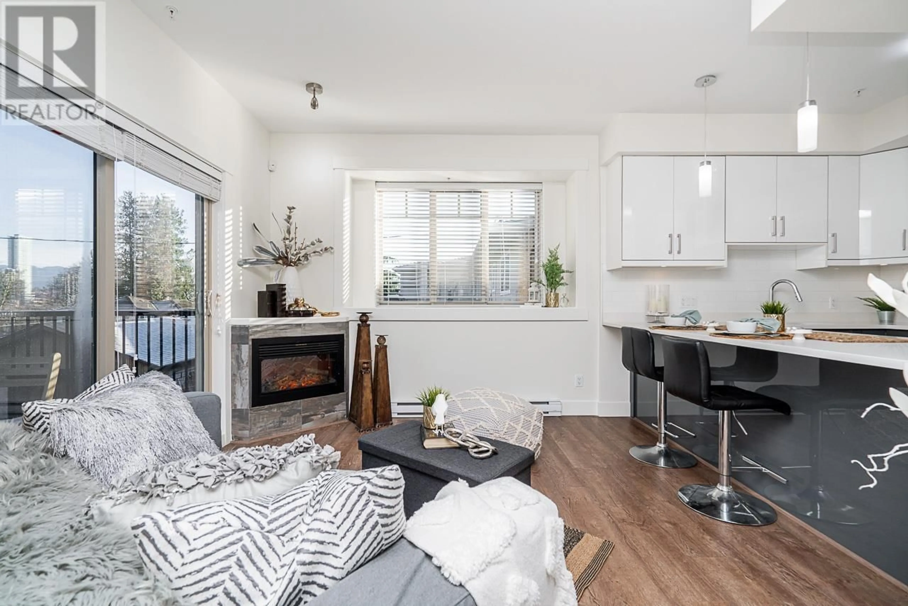 Living room with furniture, wood/laminate floor for 14 4033 DOMINION STREET, Burnaby British Columbia V5G0C2