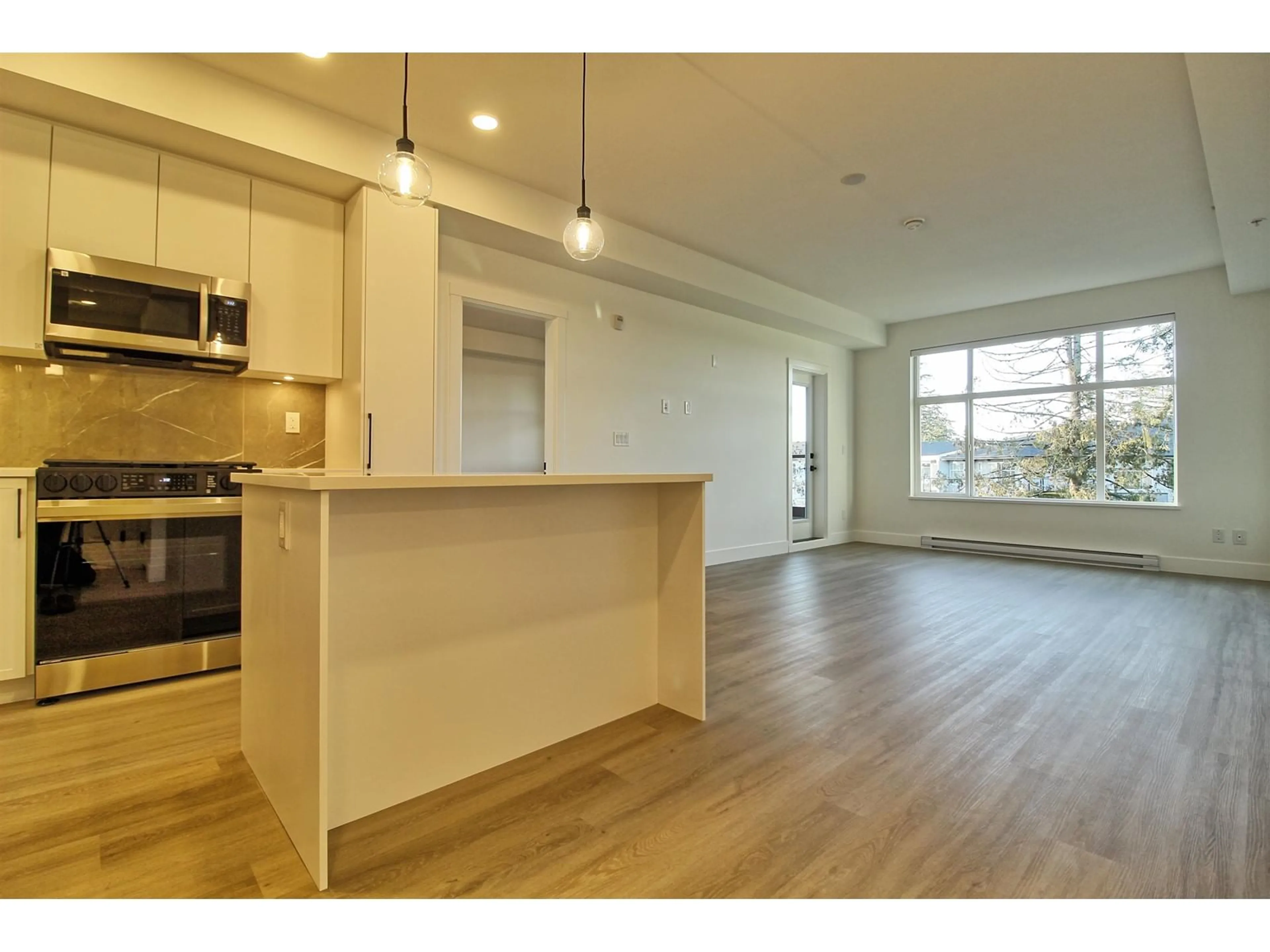 Open concept kitchen, wood/laminate floor for 615 - 3480 146A, Surrey British Columbia V4P0H6