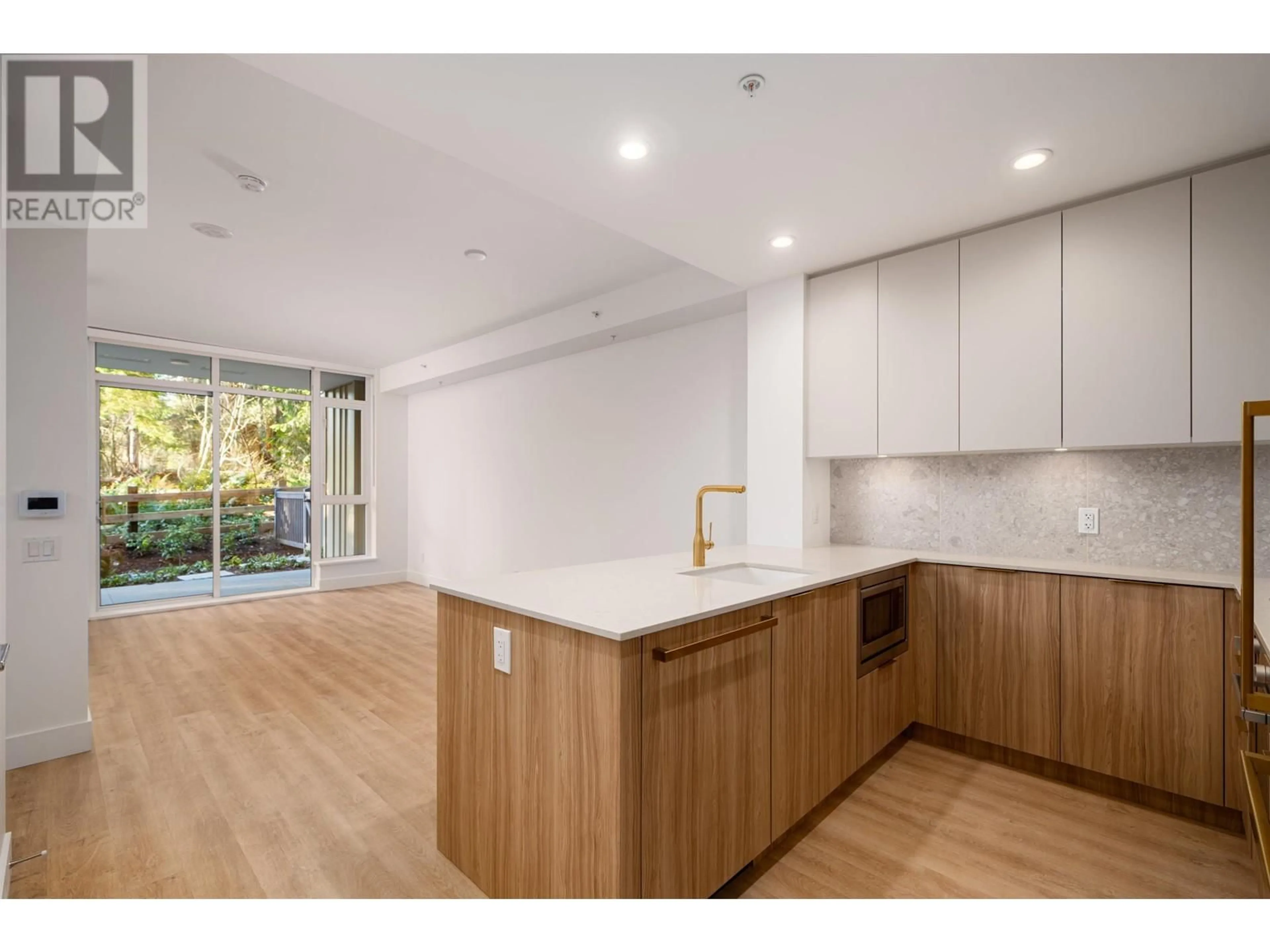 Open concept kitchen, wood/laminate floor for 202 - 2325 EMERY COURT, North Vancouver British Columbia V7J0E8