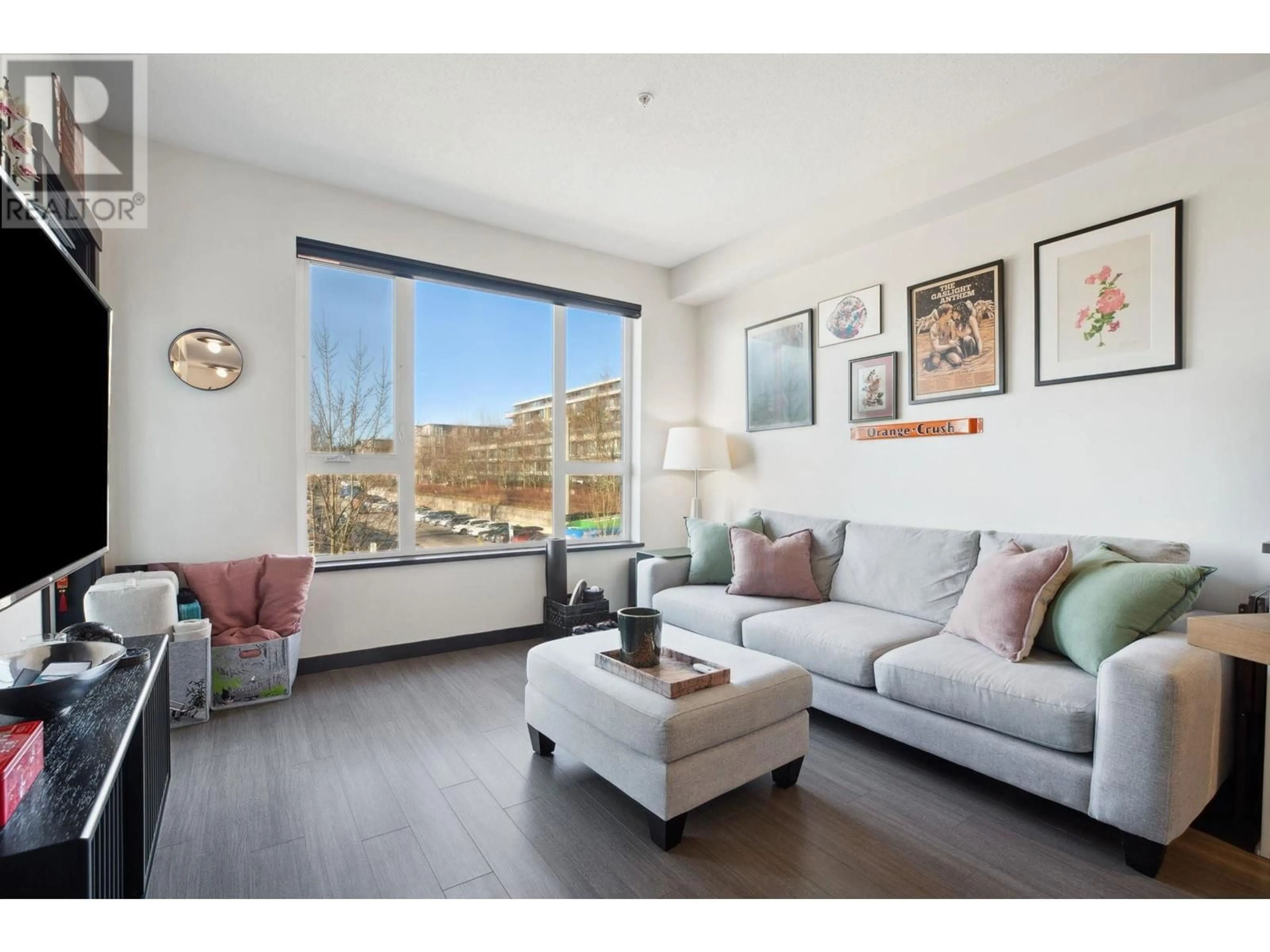 Living room with furniture, wood/laminate floor for 311 9168 SLOPES MEWS, Burnaby British Columbia V5A0E4