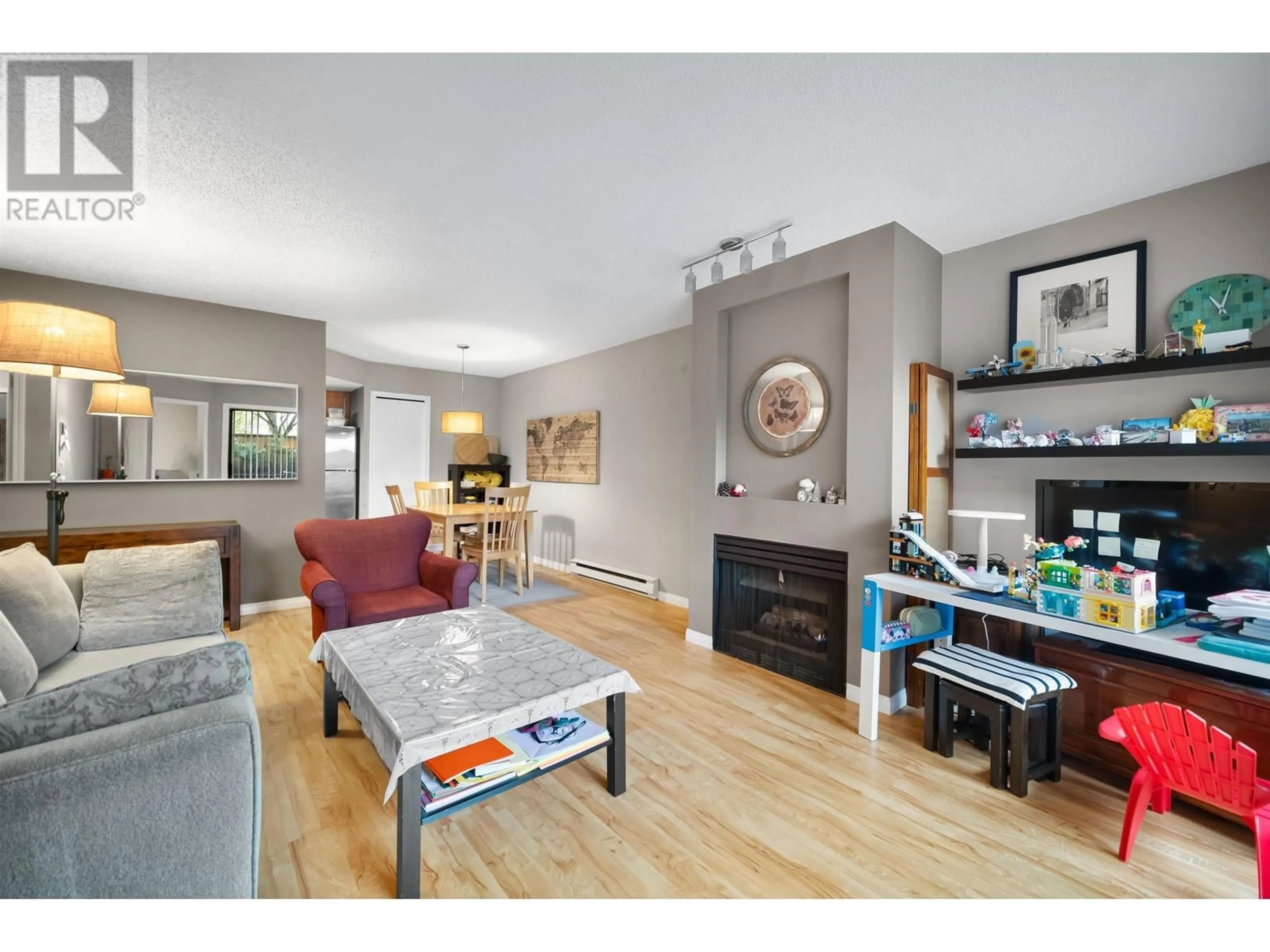 Living room with furniture, wood/laminate floor for 118 2925 GLEN DRIVE, Coquitlam British Columbia V3B7H9