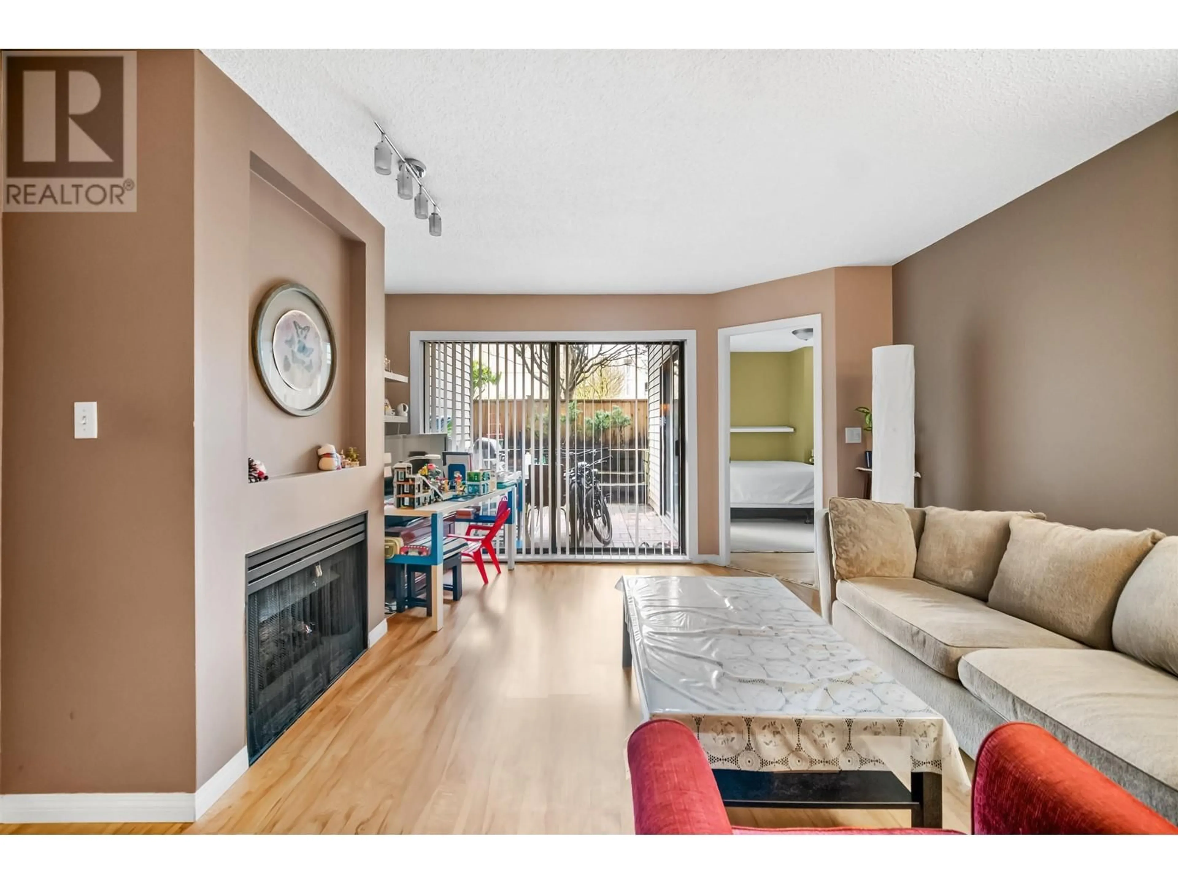 Living room with furniture, wood/laminate floor for 118 2925 GLEN DRIVE, Coquitlam British Columbia V3B7H9