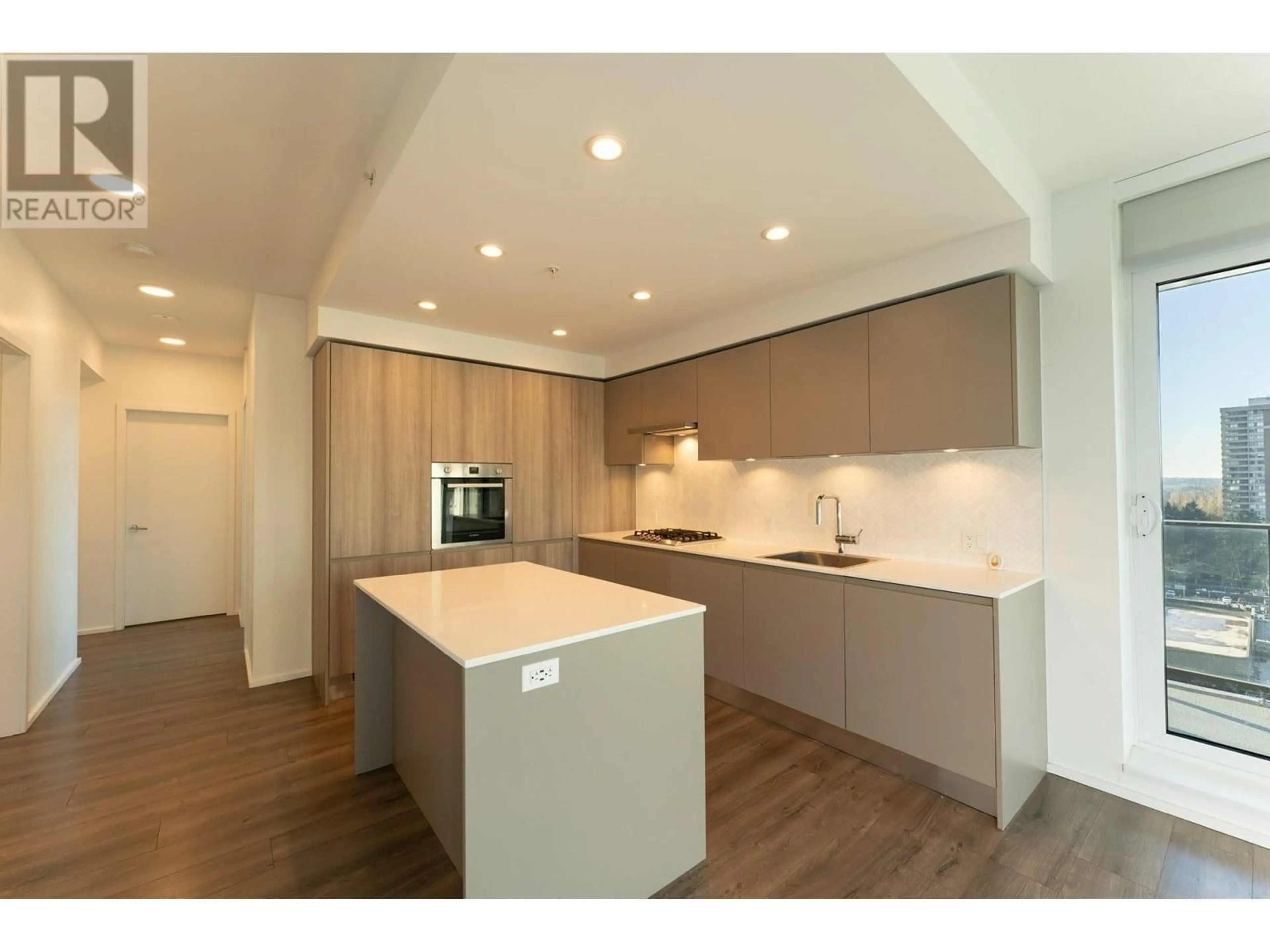 Open concept kitchen, wood/laminate floor for 709 3809 EVERGREEN PLACE, Burnaby British Columbia V3J0M1