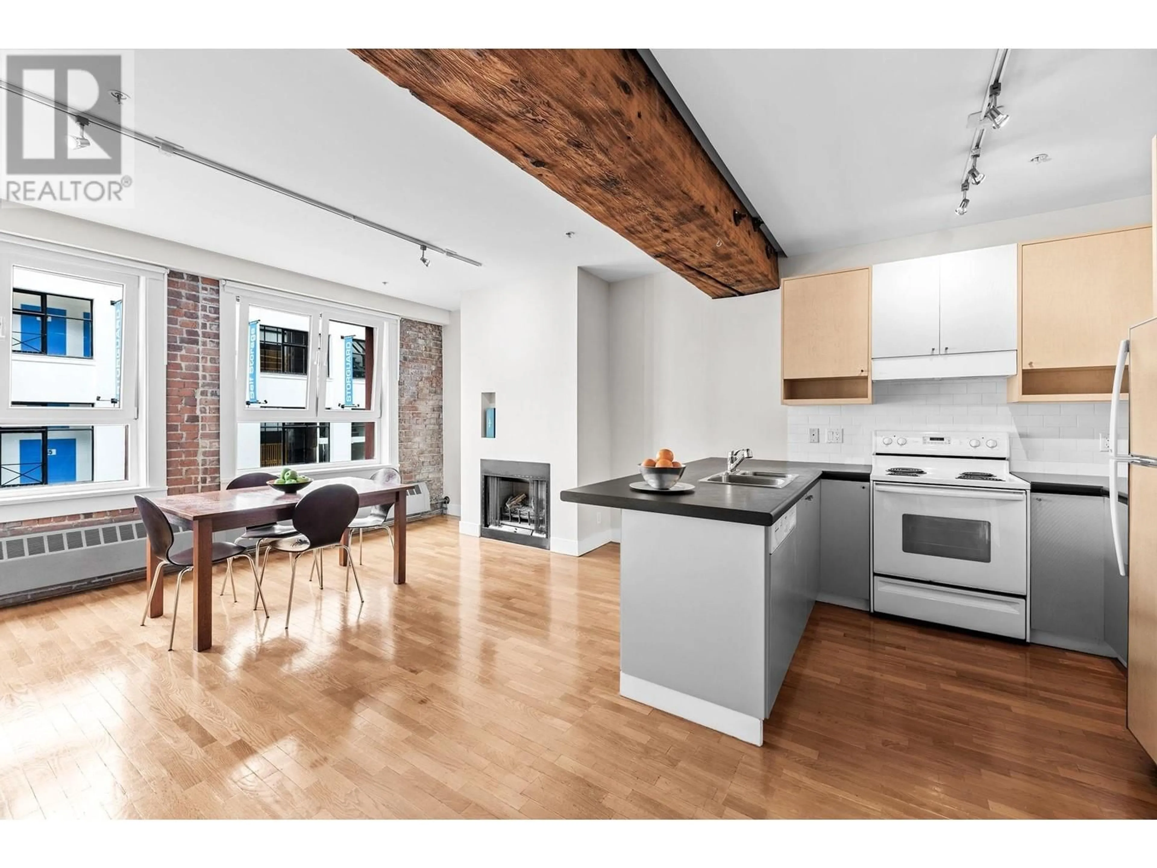 Open concept kitchen, wood/laminate floor for 201 869 BEATTY STREET, Vancouver British Columbia V6B2M6