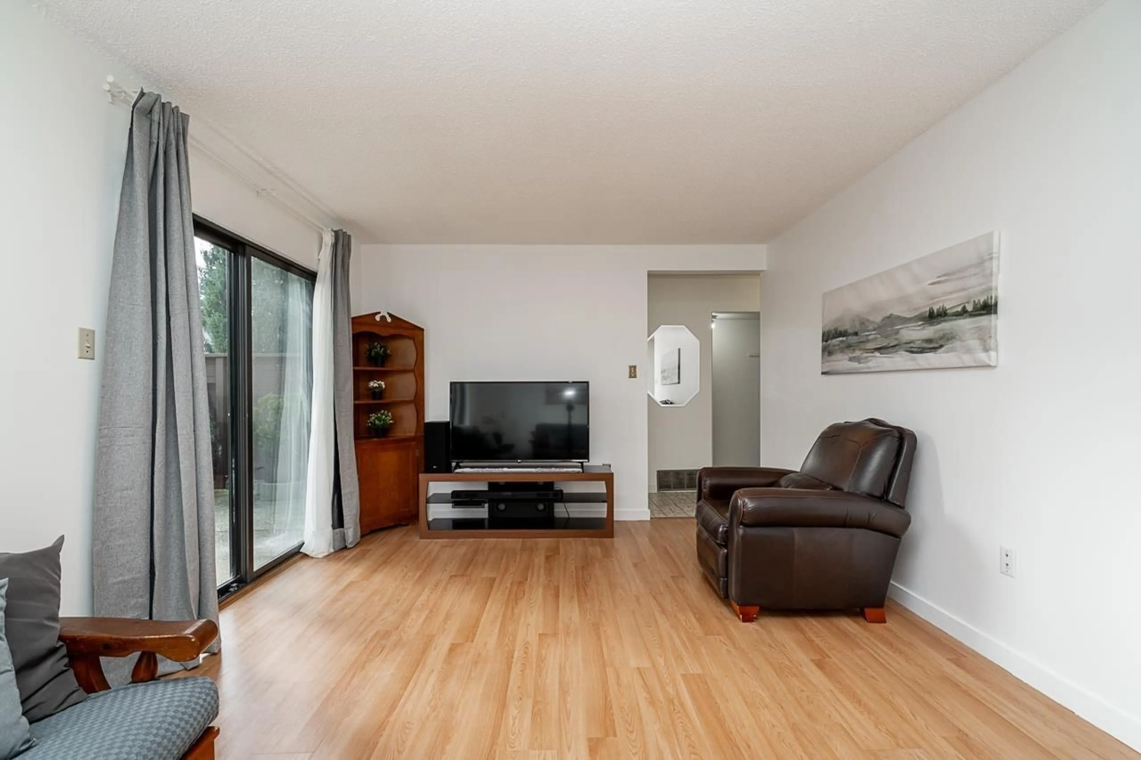 Living room with furniture, wood/laminate floor for 113 14153 104 AVENUE, Surrey British Columbia V3T1X6