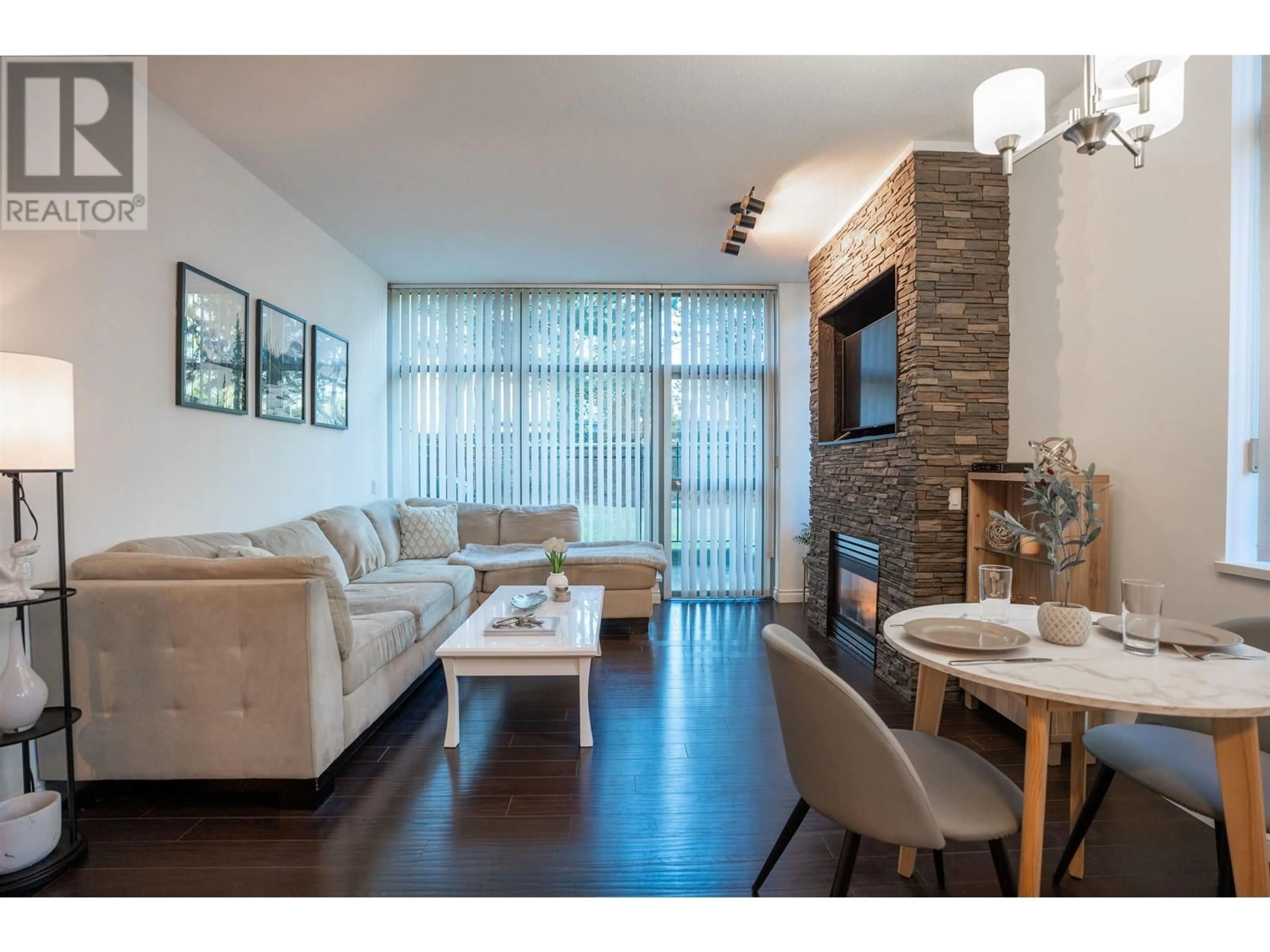 Living room with furniture, wood/laminate floor for 103 6611 SOUTHOAKS COURT, Burnaby British Columbia V5E4L5