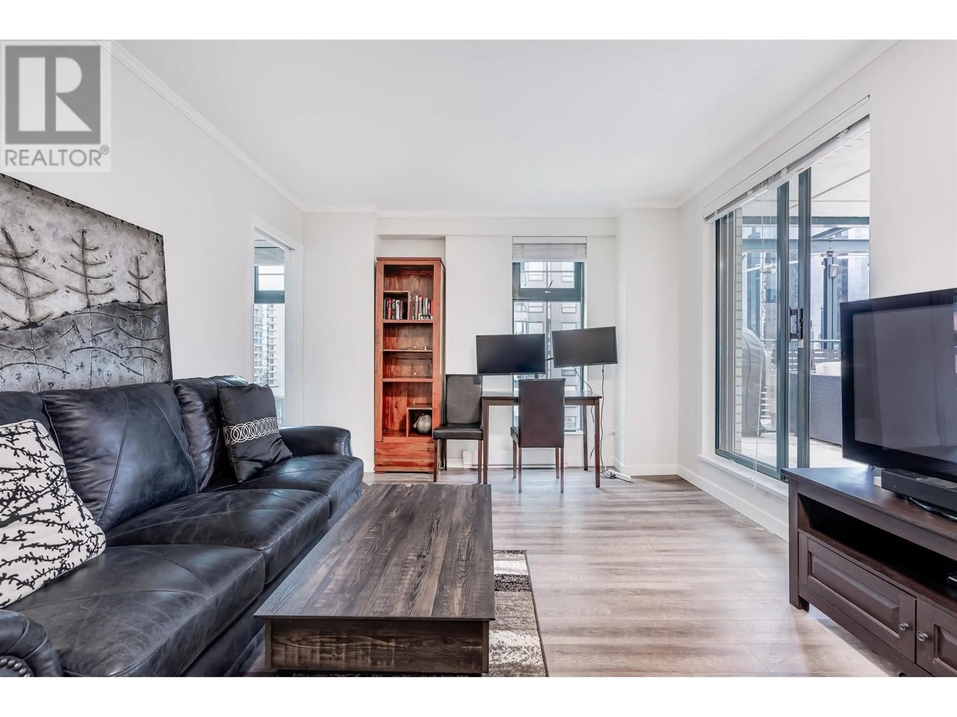 Living room with furniture, wood/laminate floor for 10A 789 HELMCKEN STREET, Vancouver British Columbia V6Z2T2