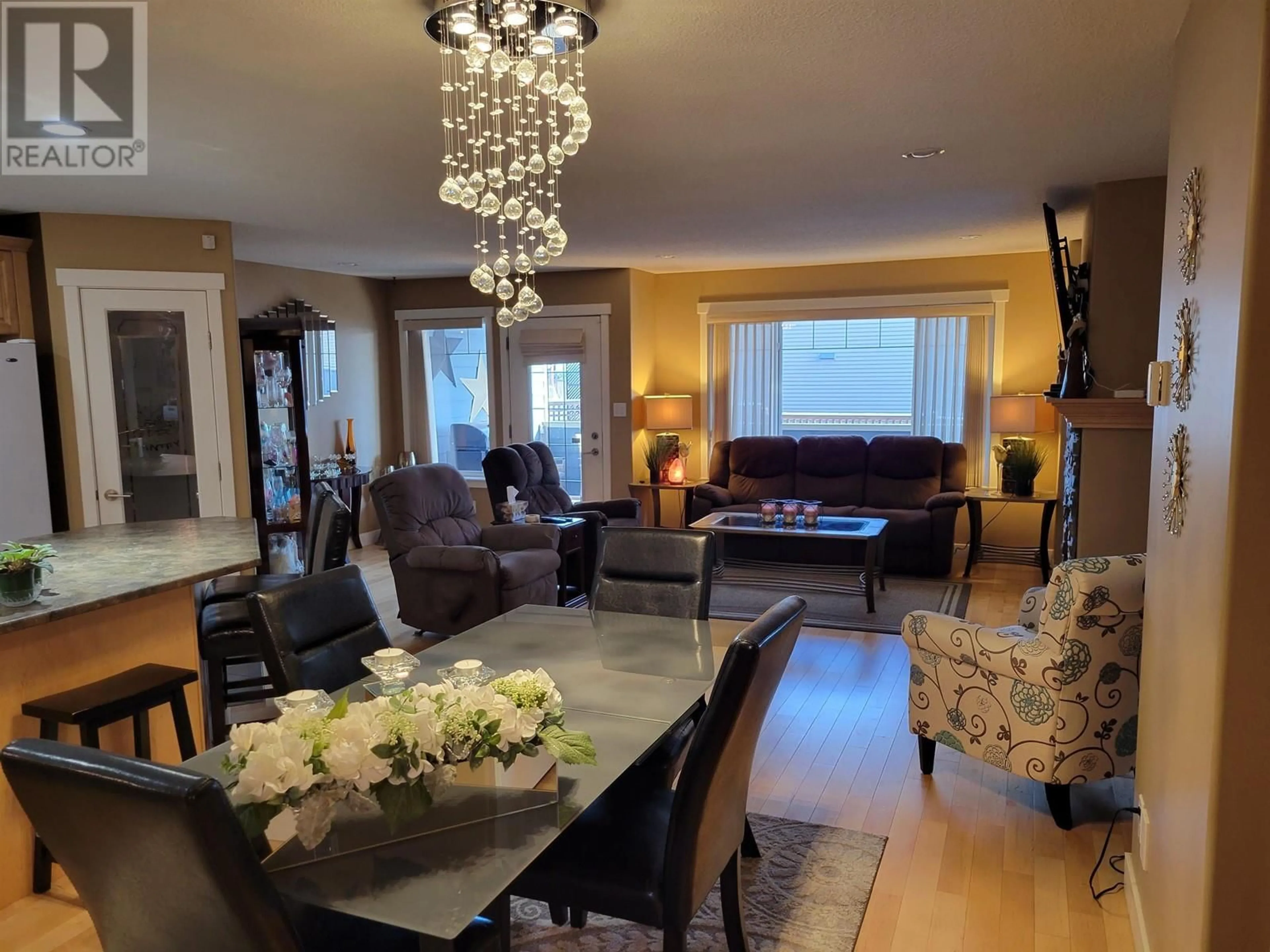 Living room with furniture, wood/laminate floor for 102 250 SEYFORTH DRIVE, Vanderhoof British Columbia V0J3A0