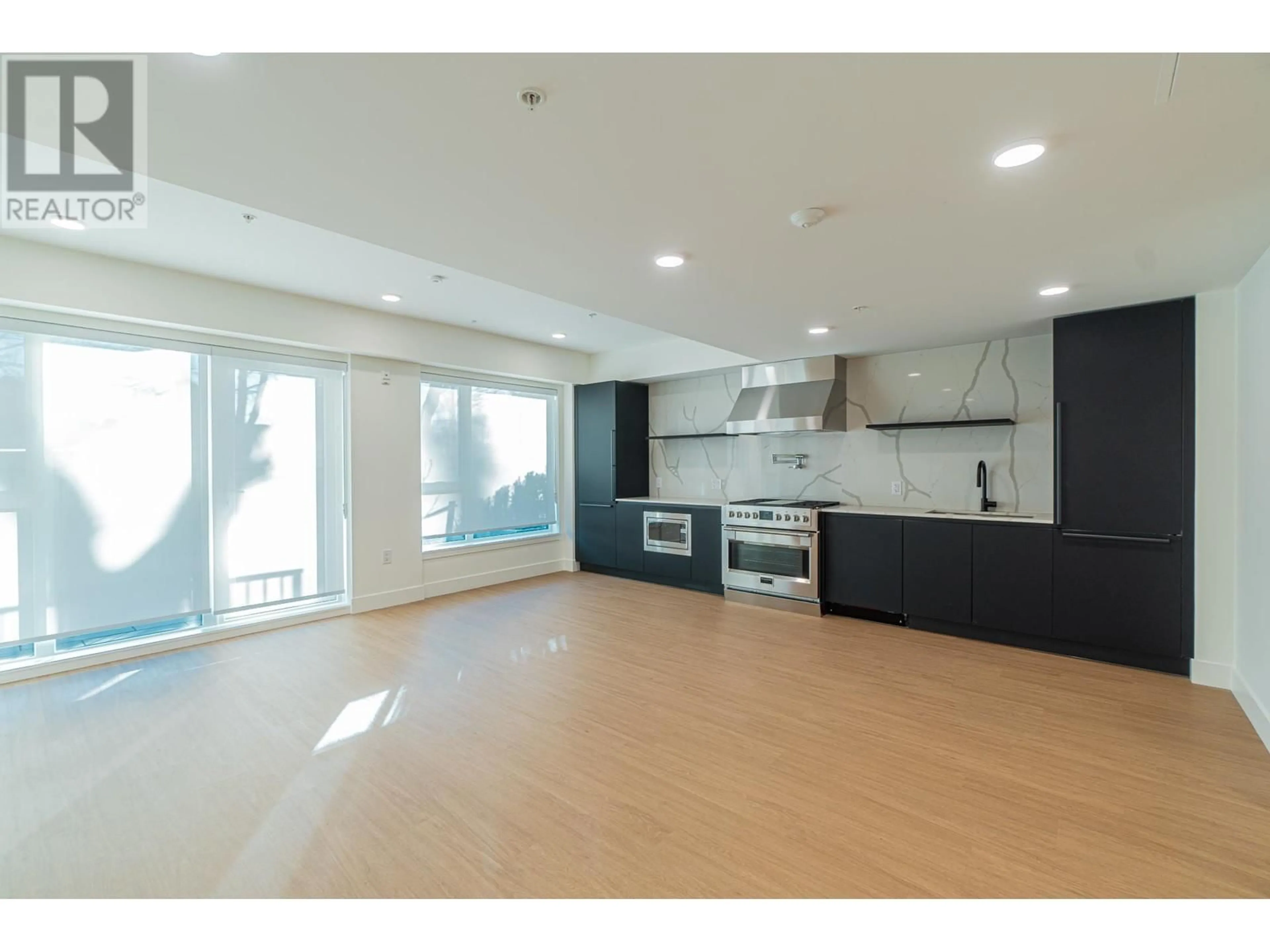 Open concept kitchen, wood/laminate floor for 205 2235 E BROADWAY, Vancouver British Columbia V5N0J5