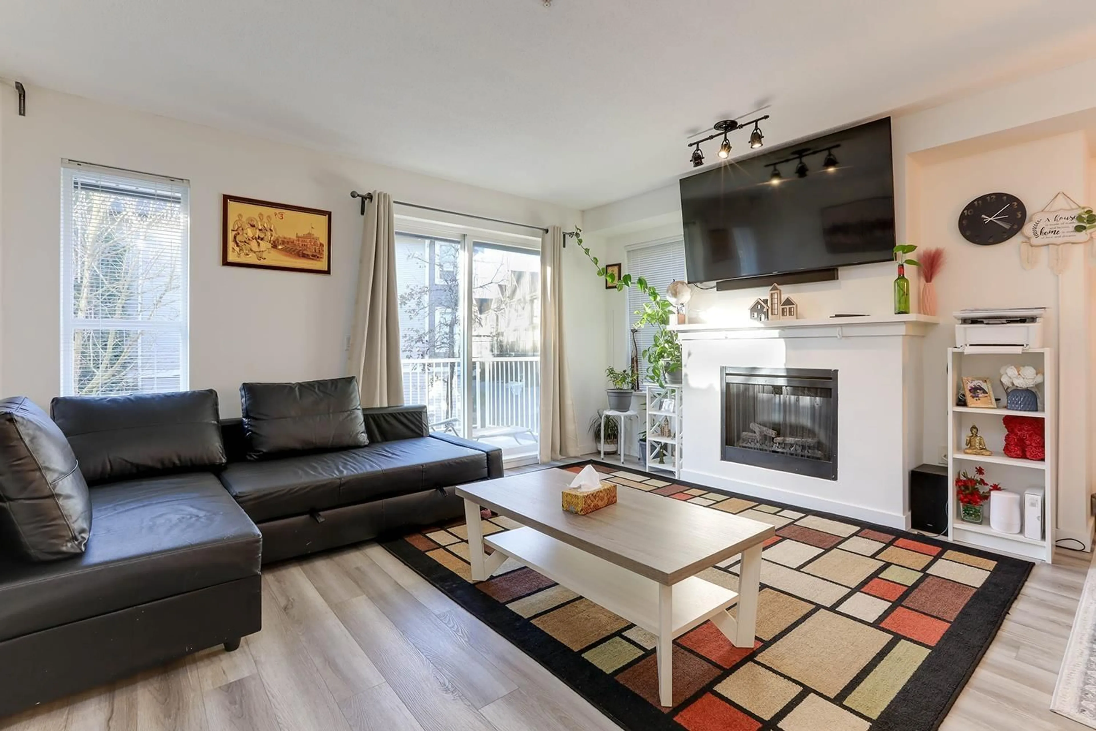 Living room with furniture, wood/laminate floor for 104 6747 203 STREET, Langley British Columbia V2Y3B5