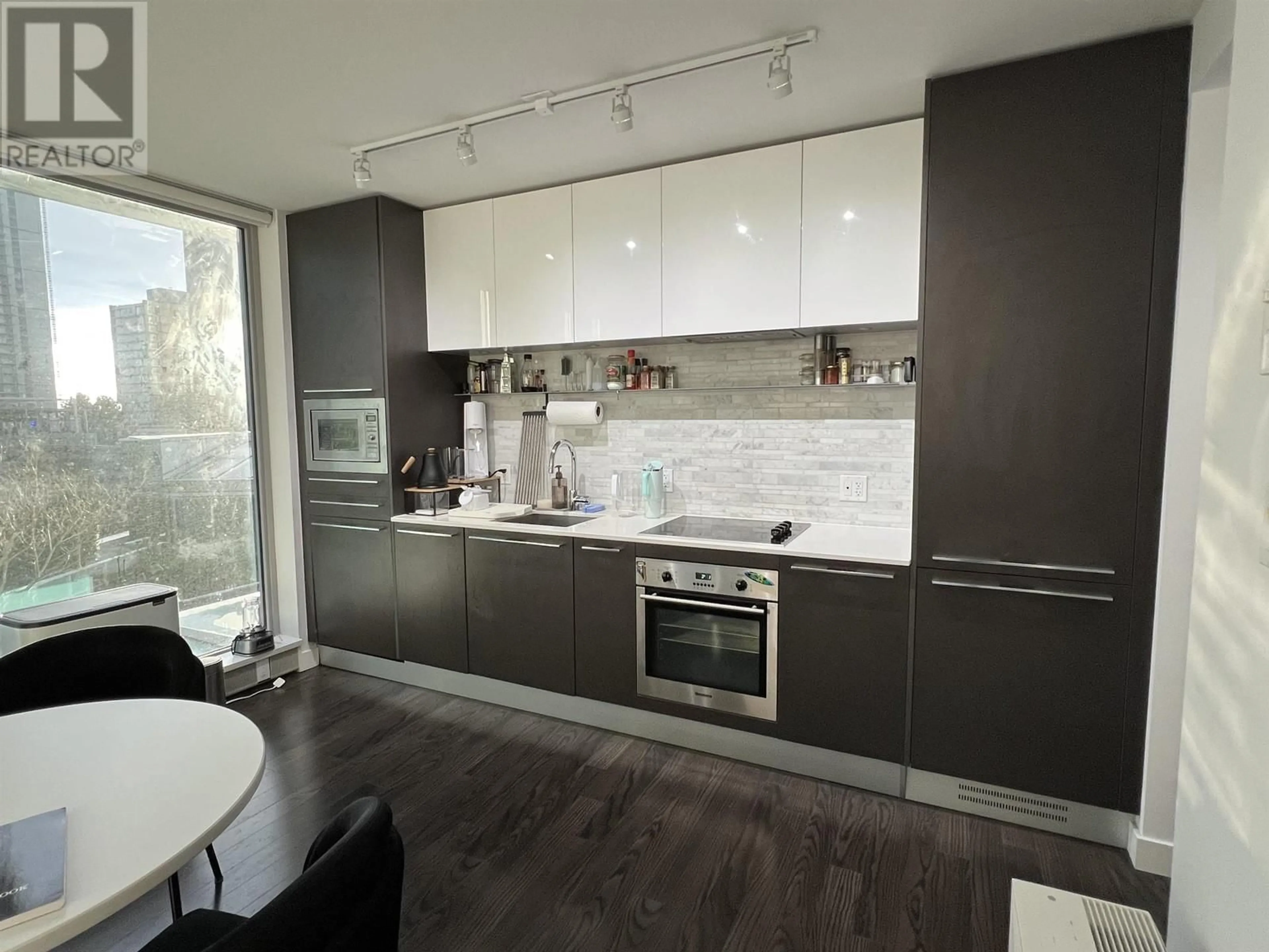 Contemporary kitchen, wood/laminate floor for 305 8131 NUNAVUT LANE, Vancouver British Columbia V5X0E2