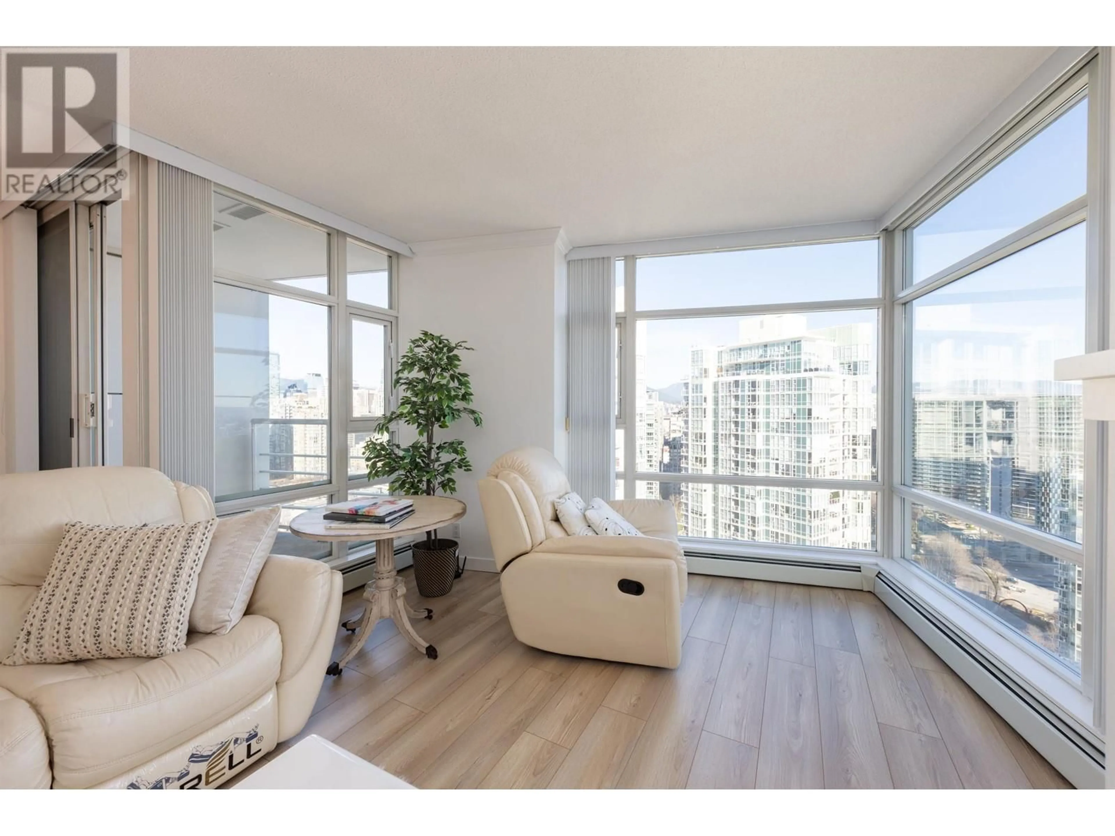 Living room with furniture, wood/laminate floor for 3303 1199 MARINASIDE CRESCENT, Vancouver British Columbia V6Z2Y2