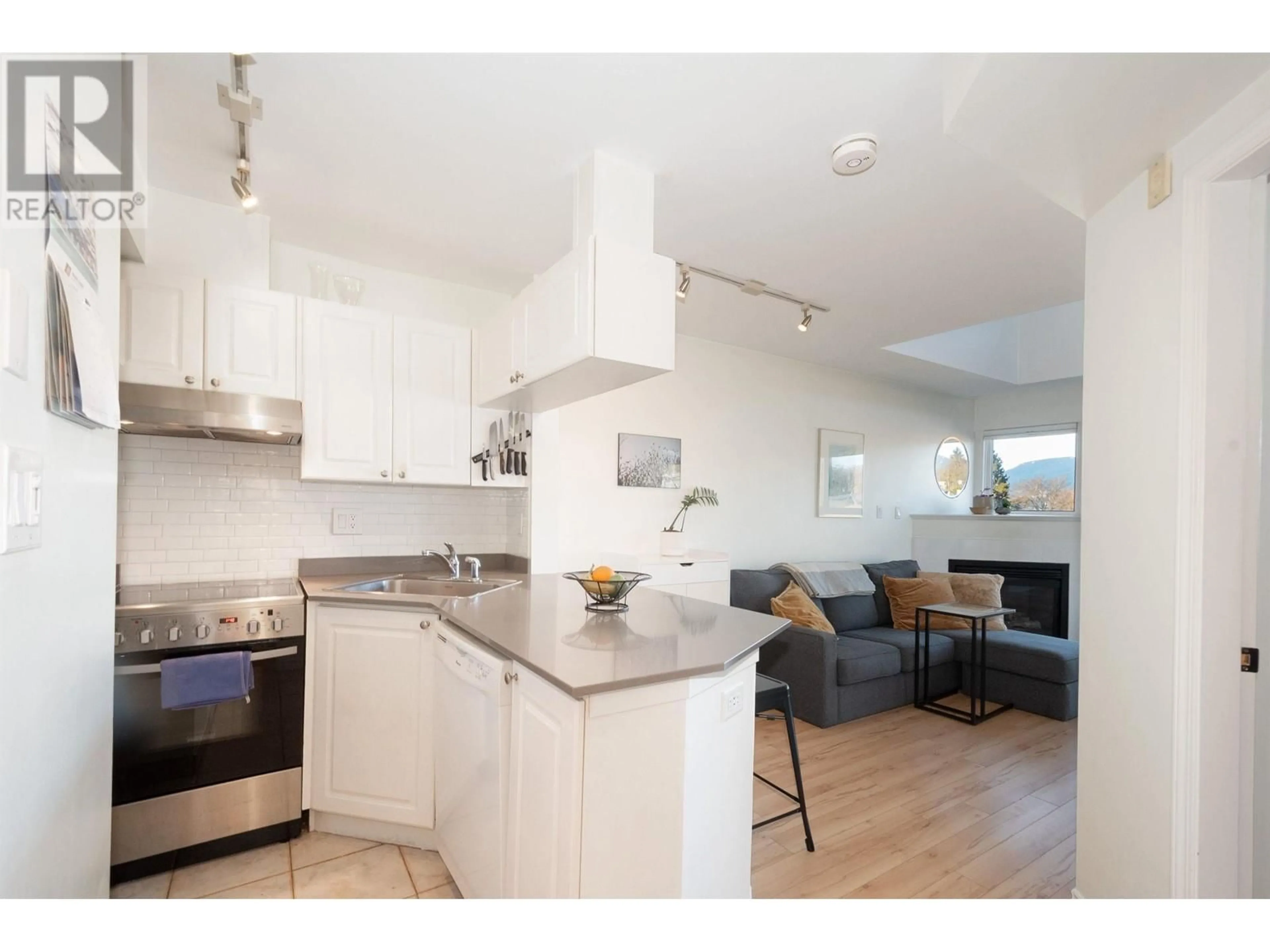 Open concept kitchen, wood/laminate floor for 401 2025 STEPHENS STREET, Vancouver British Columbia V6K3W2