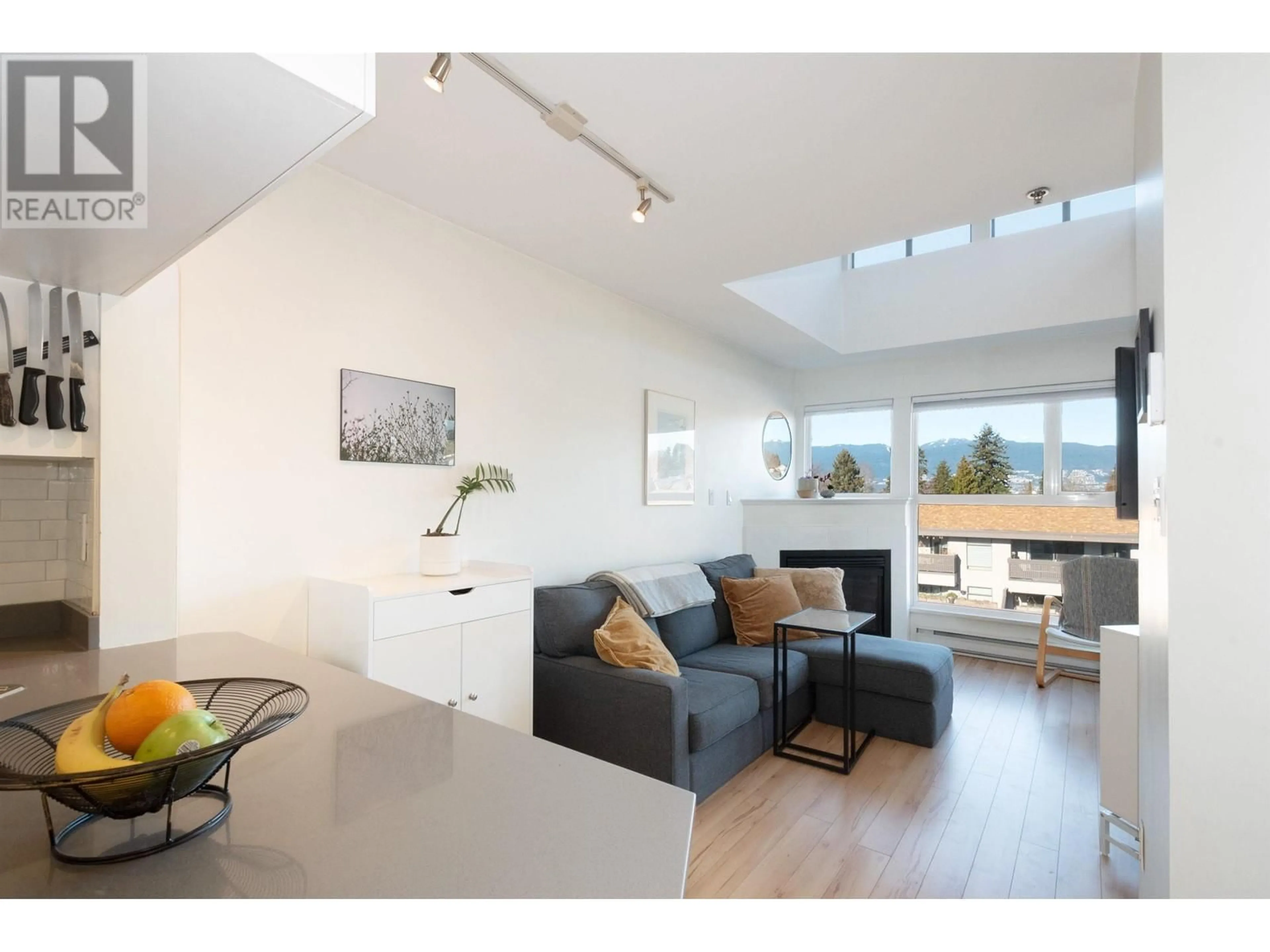 Living room with furniture, wood/laminate floor for 401 2025 STEPHENS STREET, Vancouver British Columbia V6K3W2