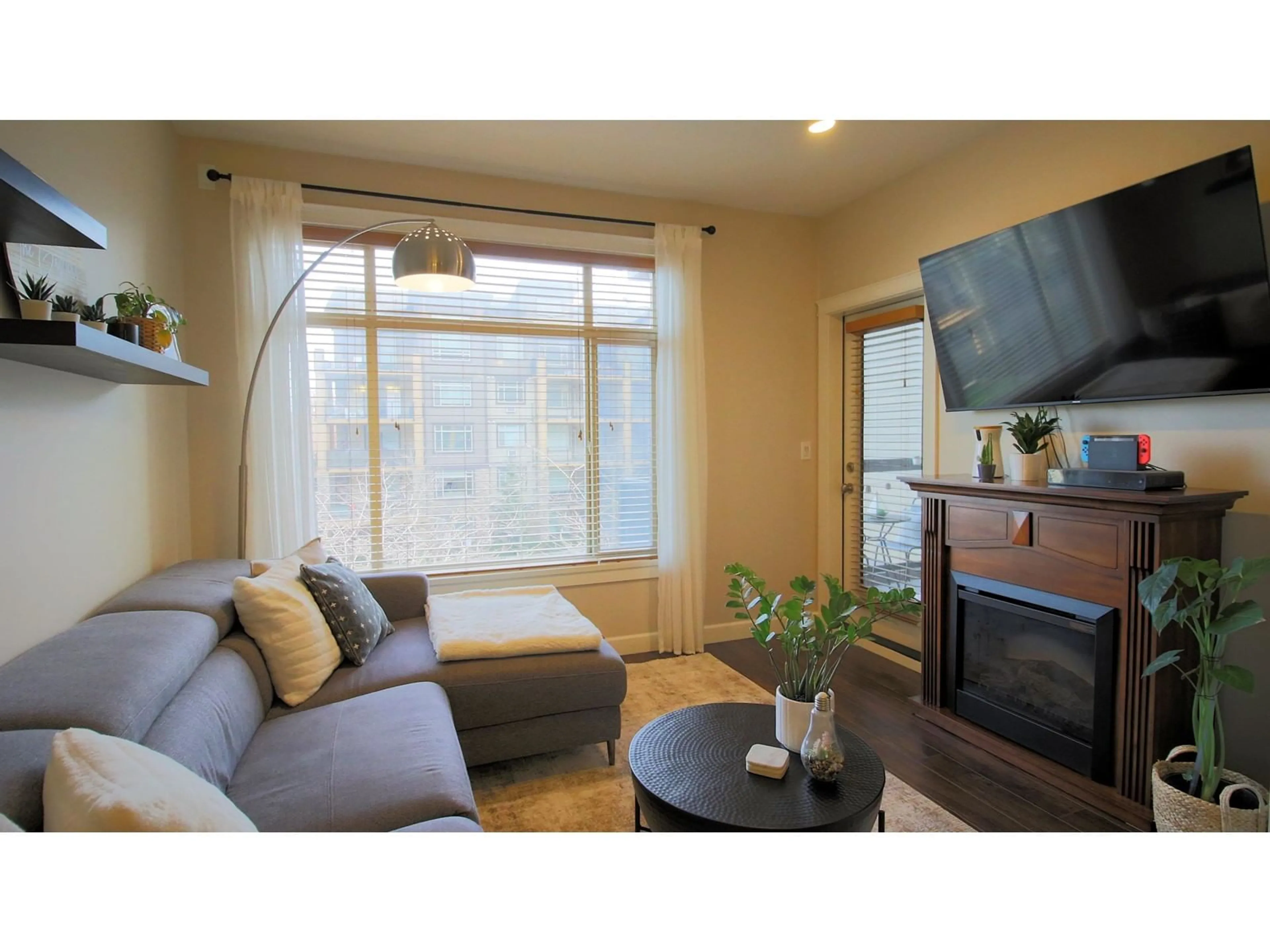 Living room with furniture, wood/laminate floor for 316 8067 207 STREET, Langley British Columbia V2Y0N9