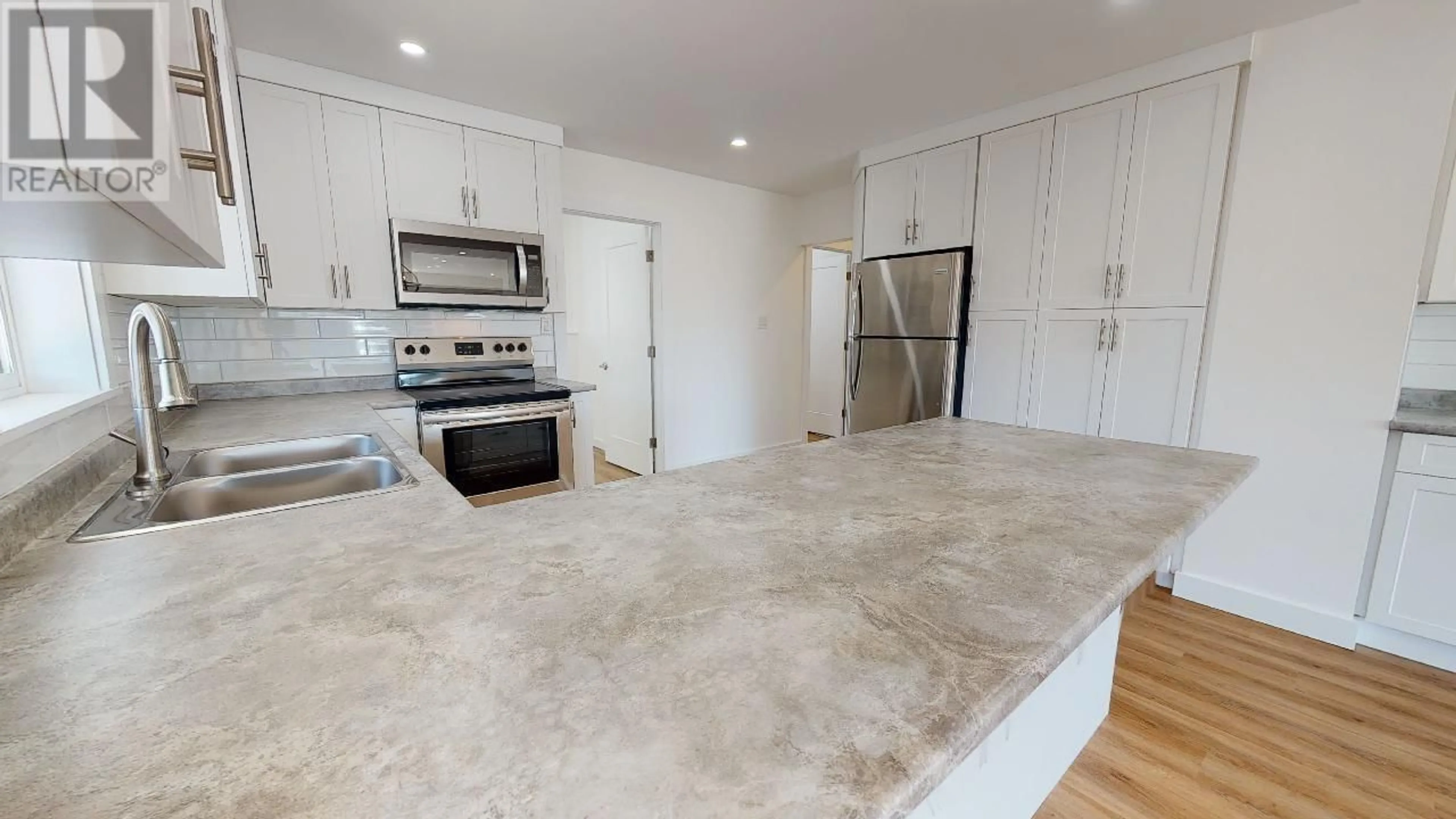 Open concept kitchen, unknown for 9908 105 AVENUE, Fort St. John British Columbia V1J2M3