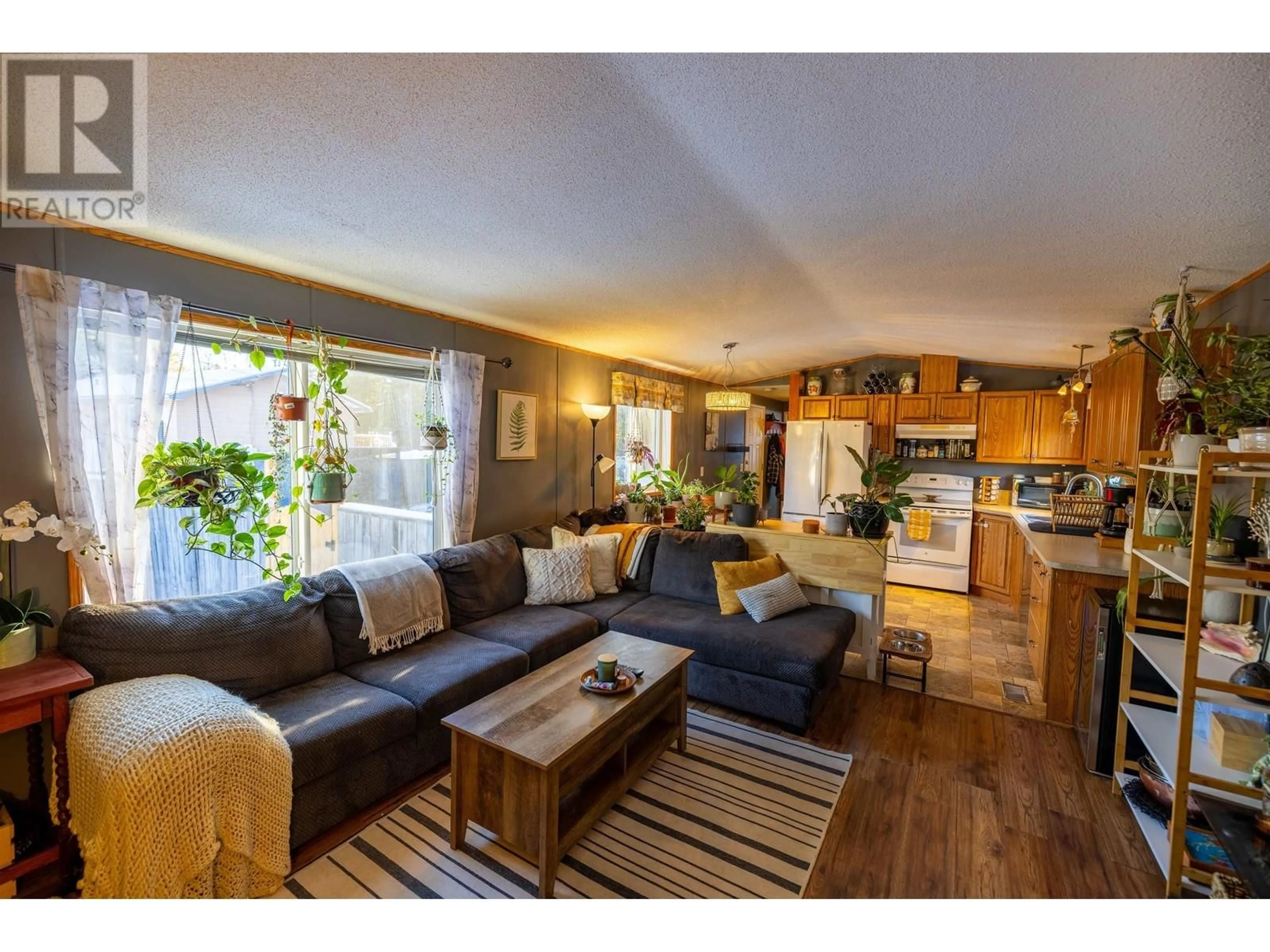 Living room with furniture, wood/laminate floor for 6827 HELM DRIVE, Prince George British Columbia V2K3S9