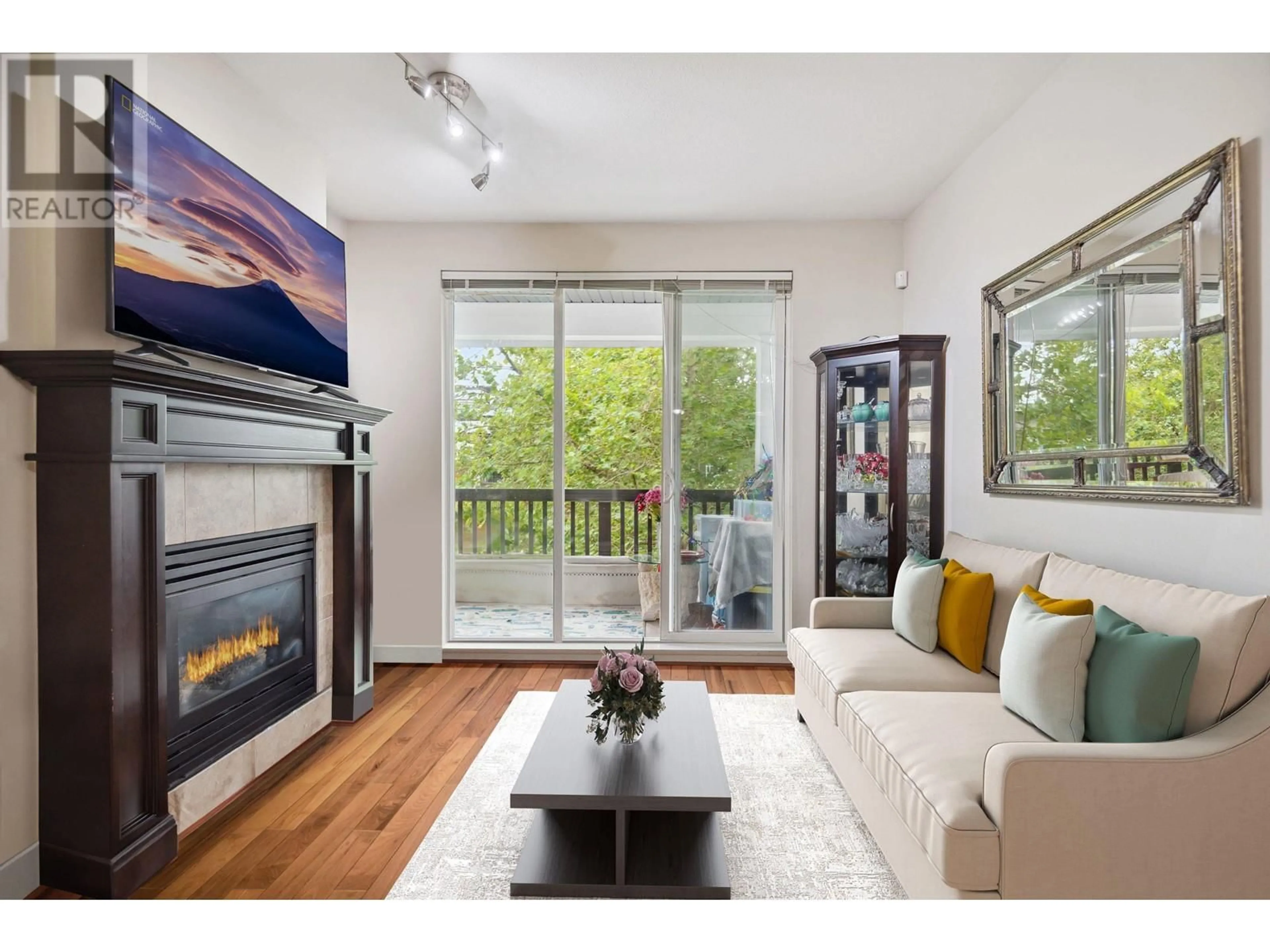 Living room with furniture, wood/laminate floor for 311 6279 EAGLES DRIVE, Vancouver British Columbia V6T2K7