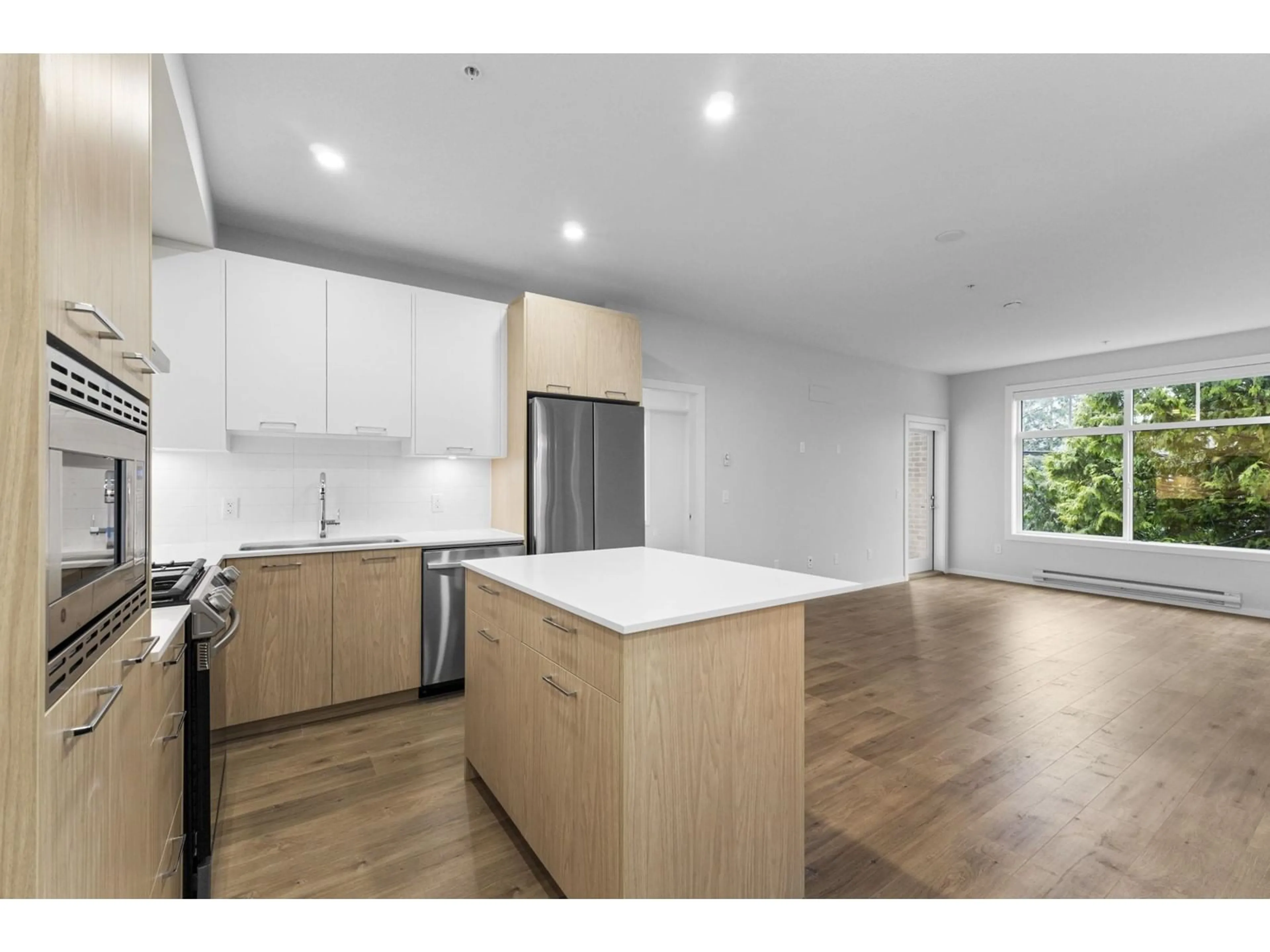 Open concept kitchen, wood/laminate floor for 308 3317 148 STREET, Surrey British Columbia V4P0H9