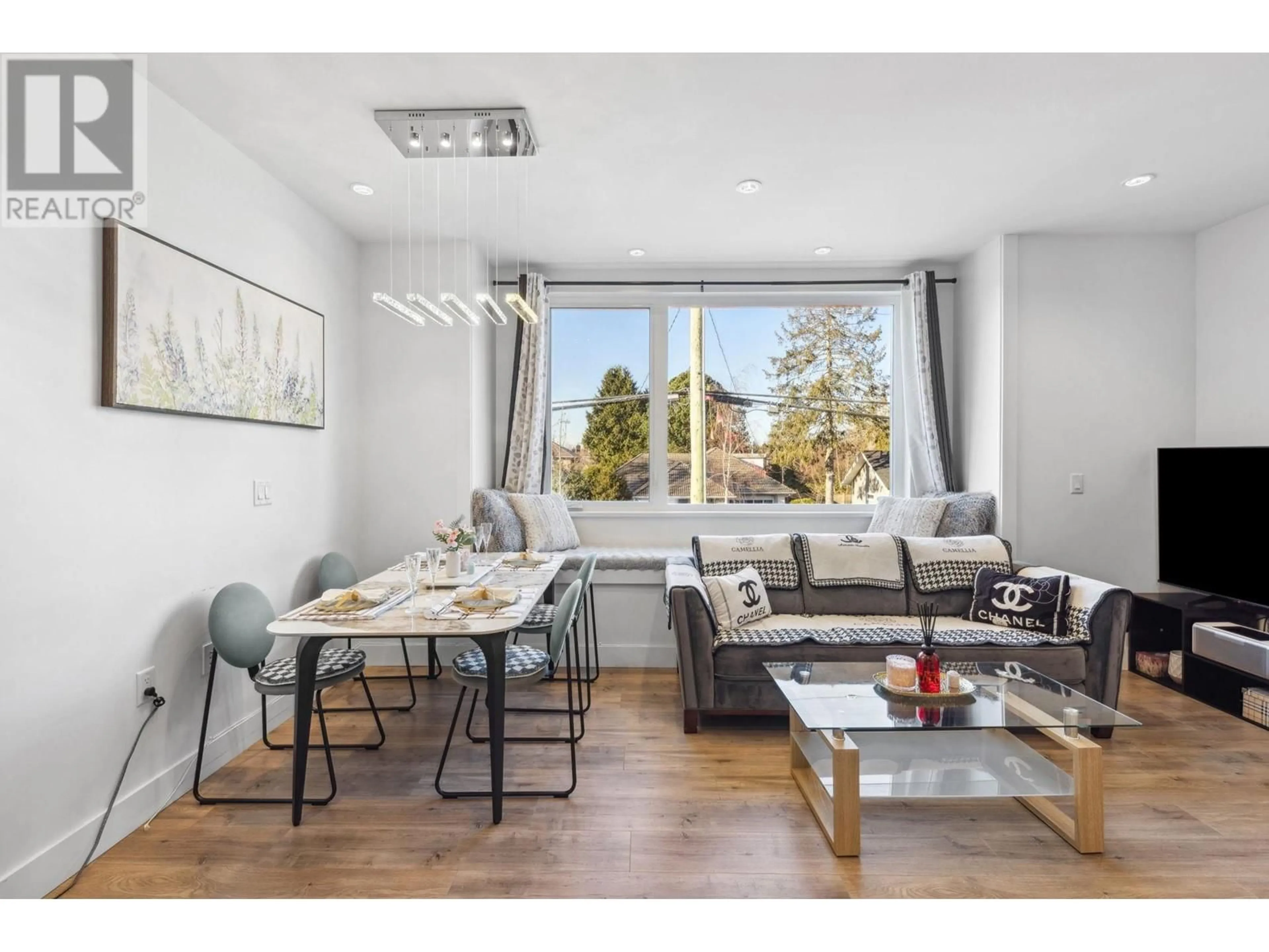 Living room with furniture, wood/laminate floor for 11 7000 WILLIAMS ROAD, Richmond British Columbia V7A1E6