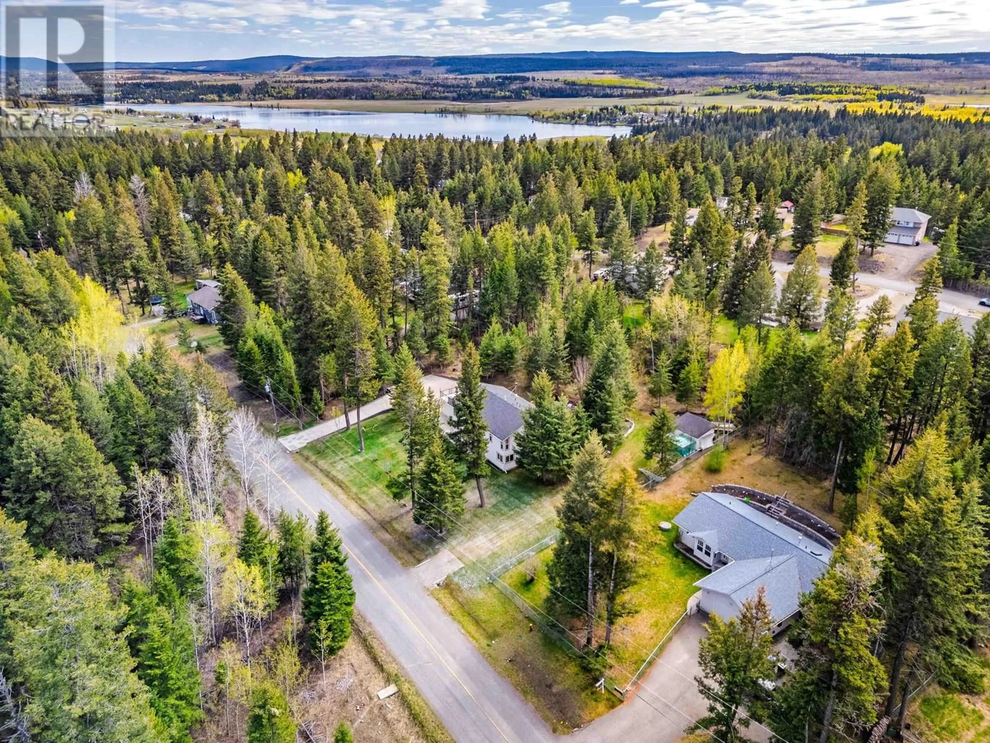 A pic from outside/outdoor area/front of a property/back of a property/a pic from drone, forest/trees view for 5091 EASZEE DRIVE, 108 Mile Ranch British Columbia V0K2Z0