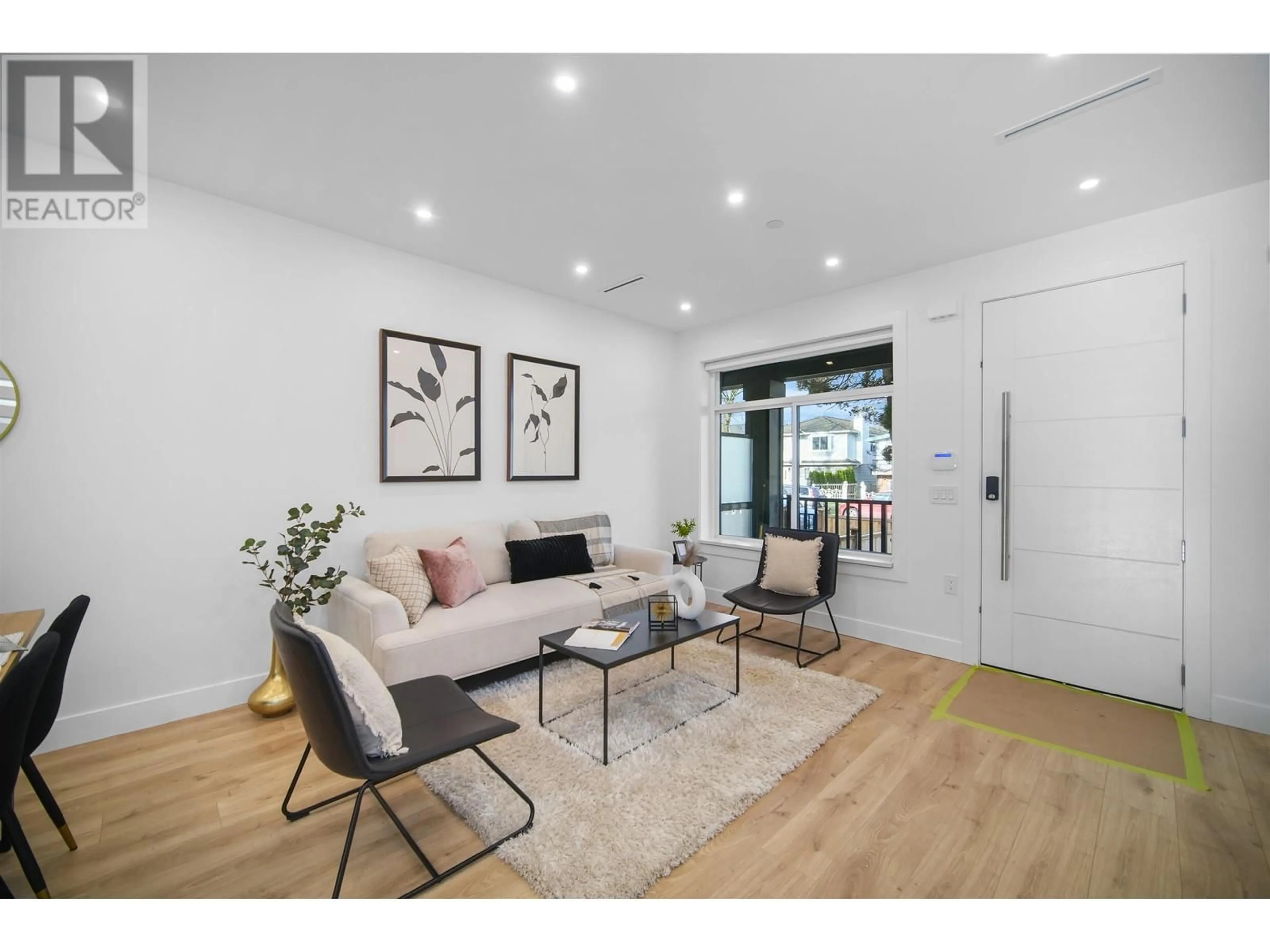 Living room with furniture, wood/laminate floor for 3384 E 2ND AVENUE, Vancouver British Columbia V5M1G5