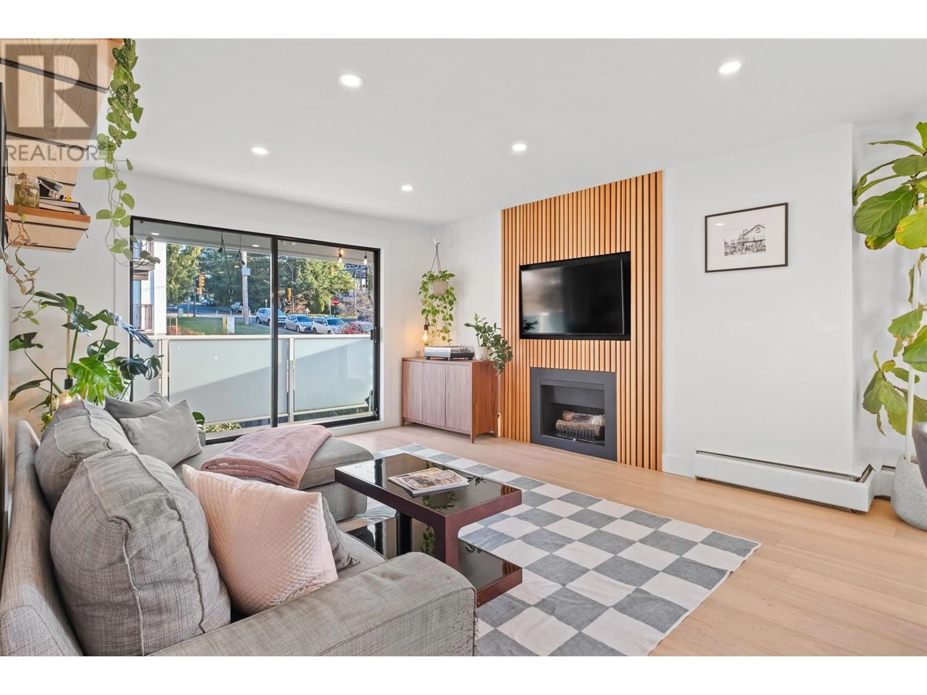 Living room with furniture, wood/laminate floor for 206 308 W 2ND STREET, North Vancouver British Columbia V7M1E1