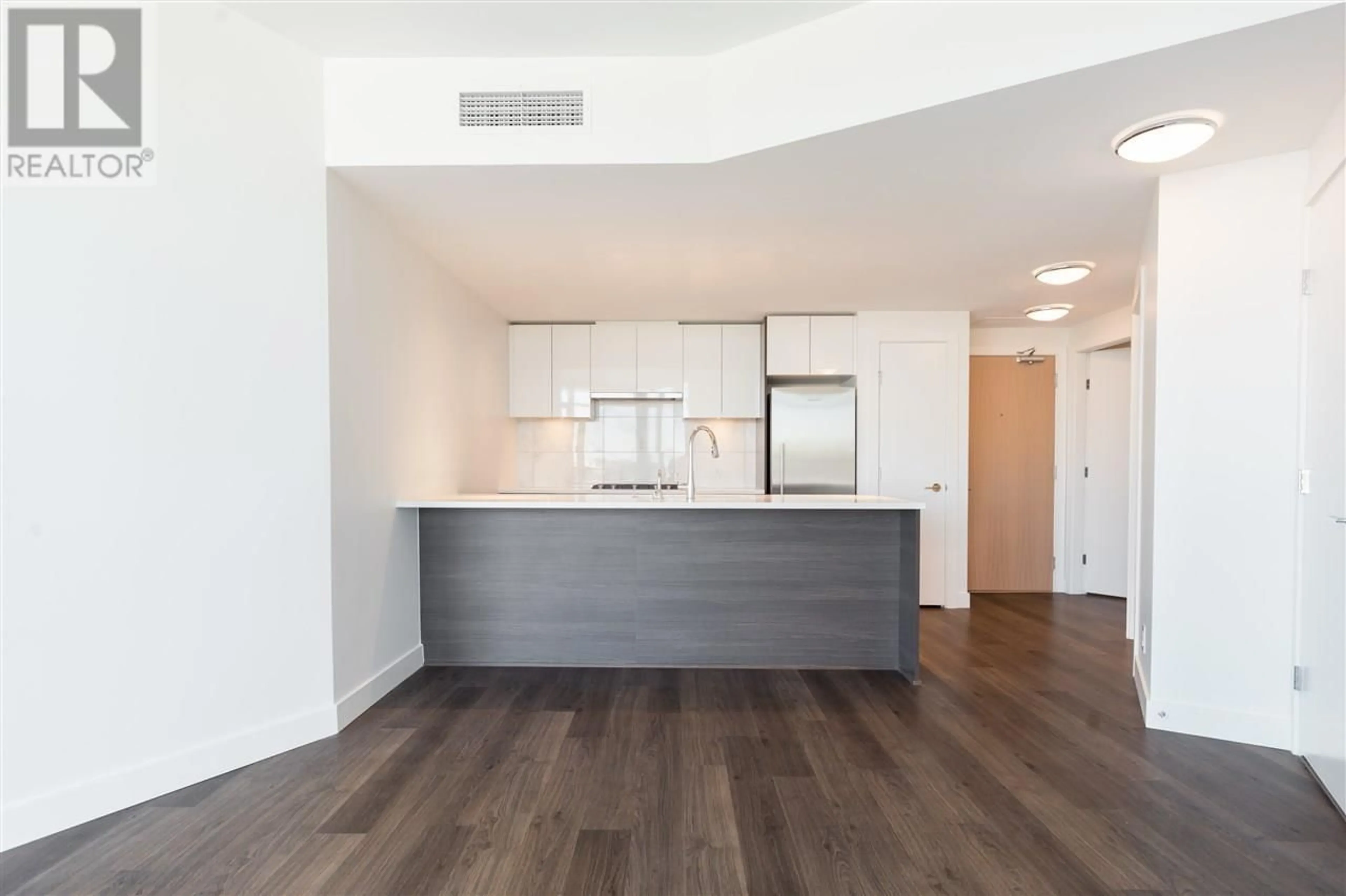 Open concept kitchen, wood/laminate floor for 710 - 3557 SAWMILL CRESCENT, Vancouver British Columbia V5S0E2