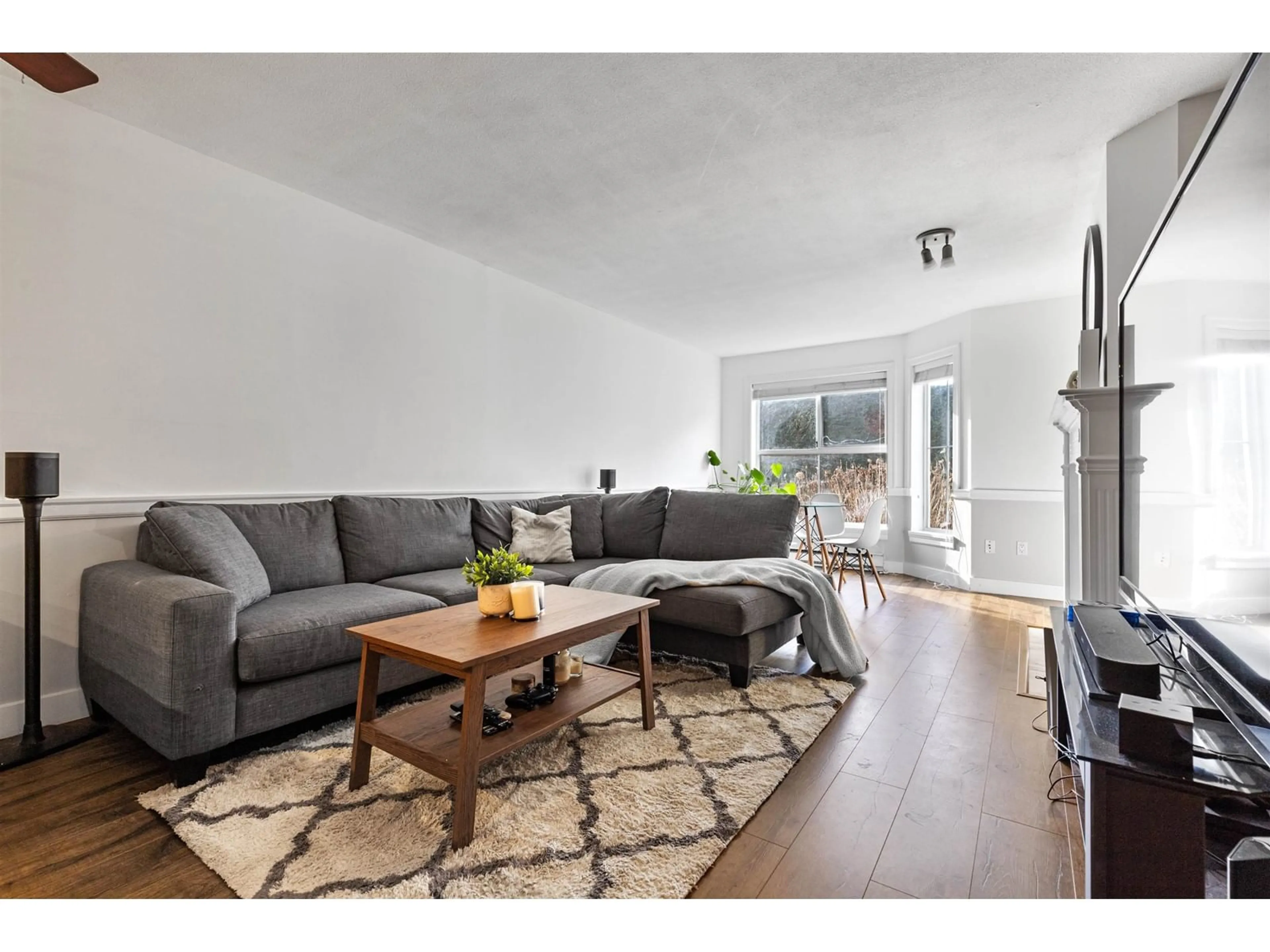 Living room with furniture, wood/laminate floor for 110 15130 108 AVENUE, Surrey British Columbia V3R0T8