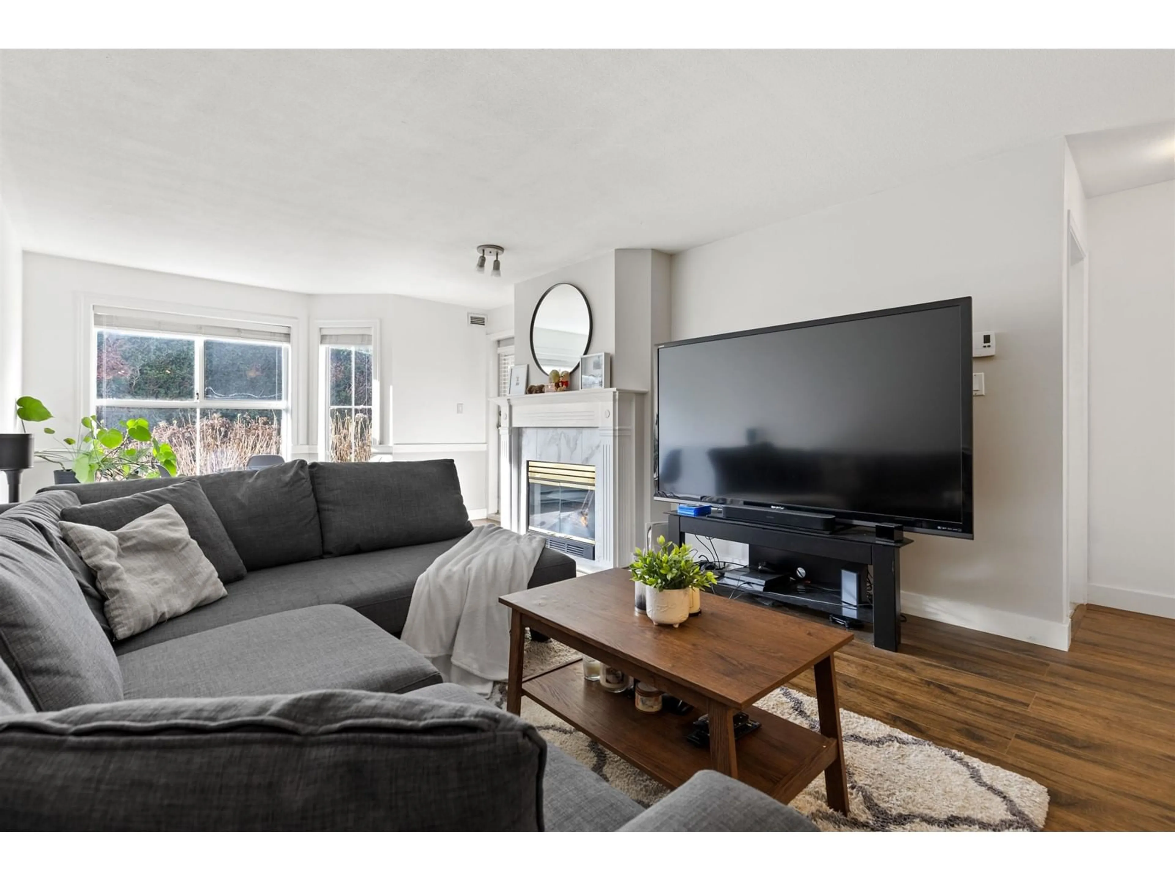 Living room with furniture, wood/laminate floor for 110 15130 108 AVENUE, Surrey British Columbia V3R0T8