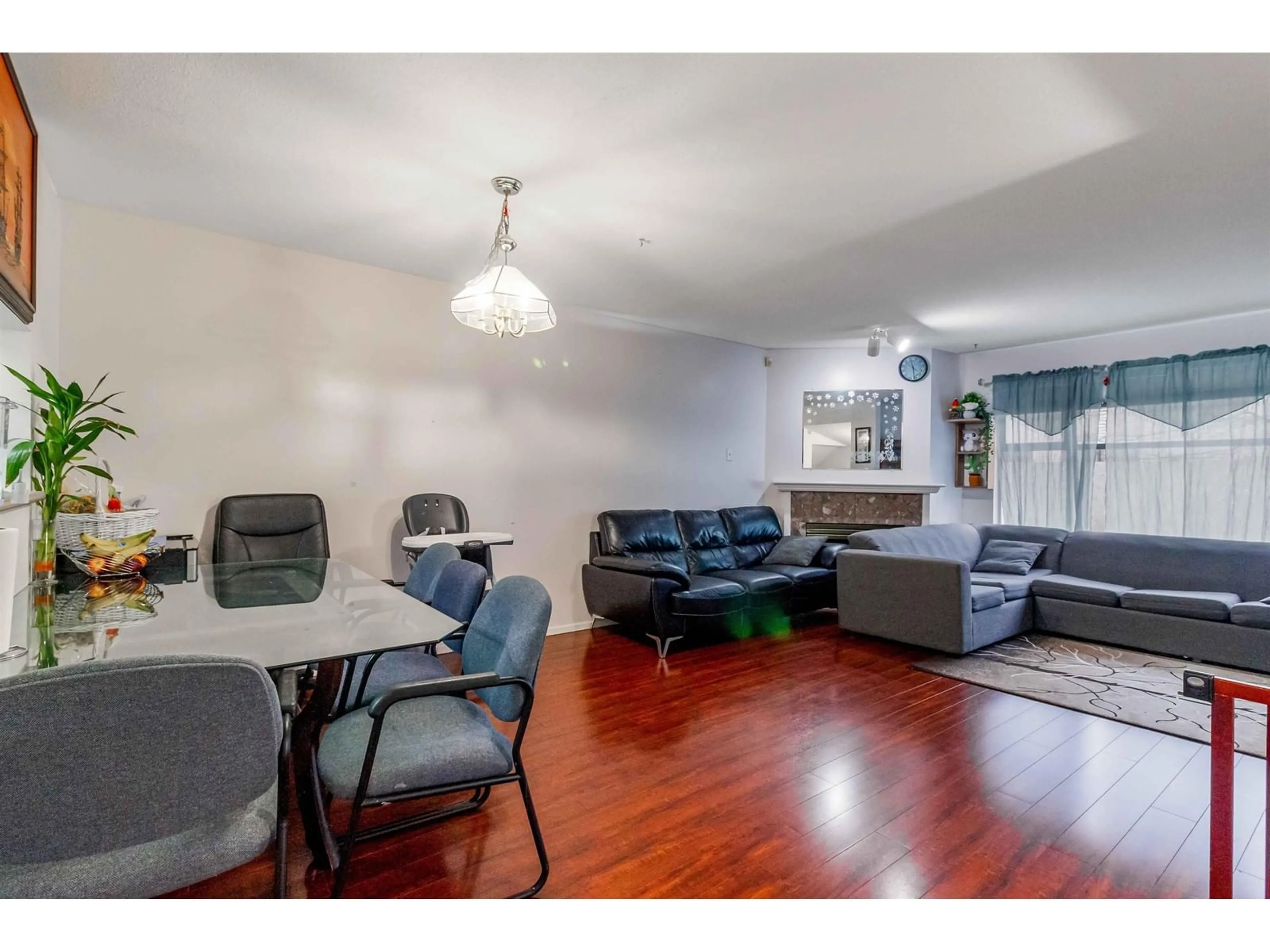 Living room with furniture, wood/laminate floor for 403 14188 103A AVENUE, Surrey British Columbia V3T5S6