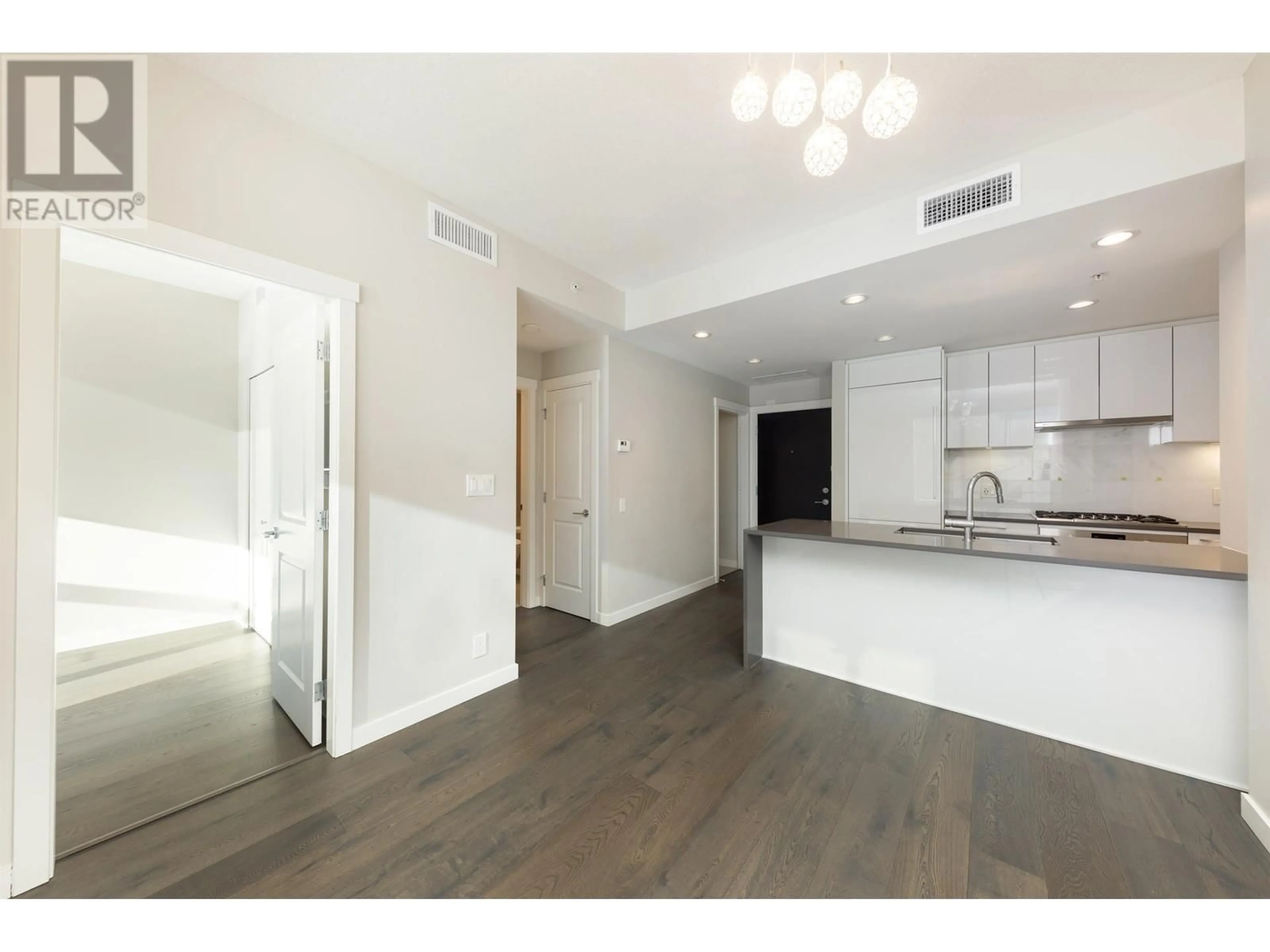 Open concept kitchen, wood/laminate floor for 309 5687 GRAY AVENUE, Vancouver British Columbia V6S0K7