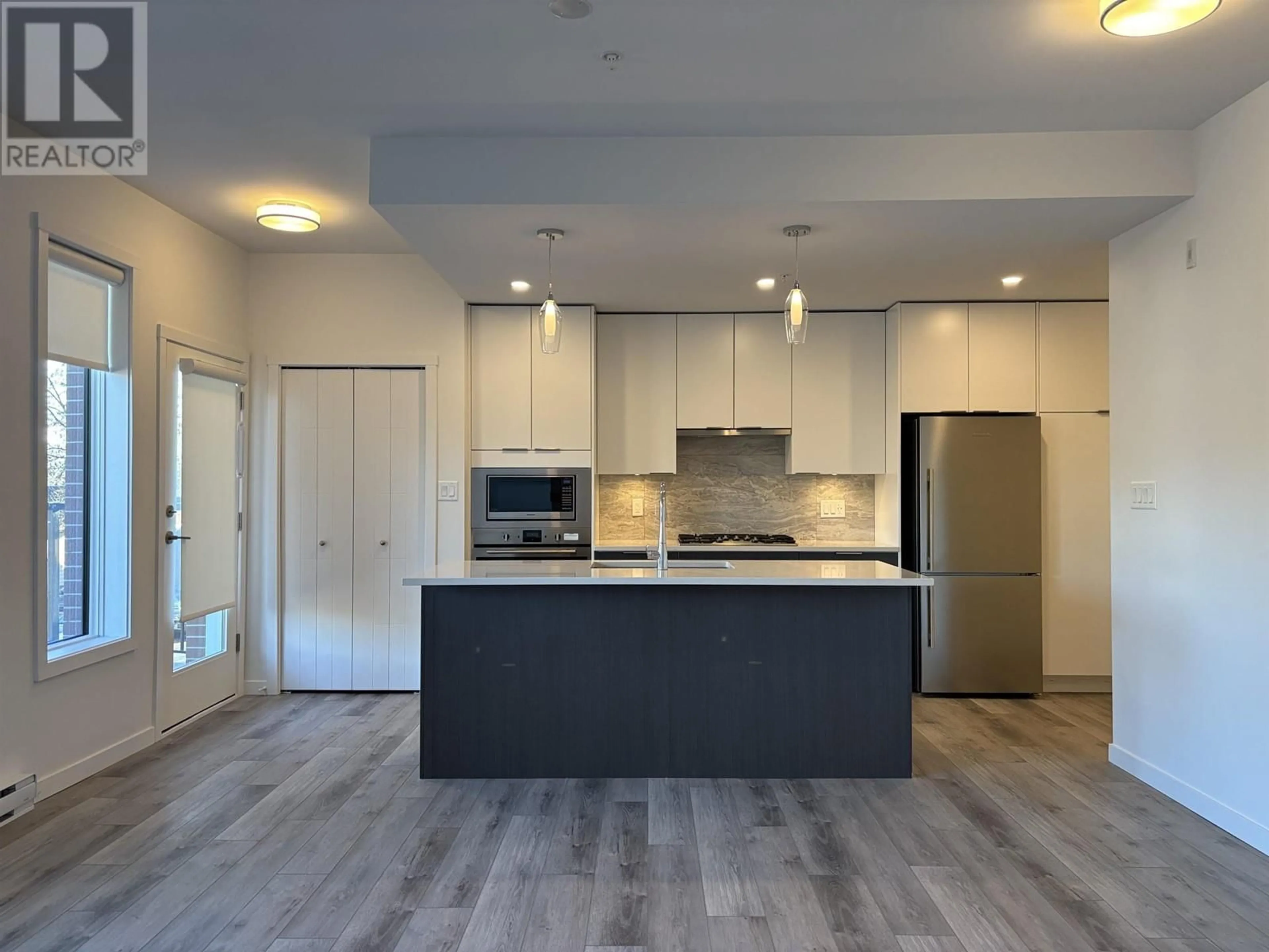 Open concept kitchen, wood/laminate floor for 104 11639 227 STREET, Maple Ridge British Columbia V2X9J6