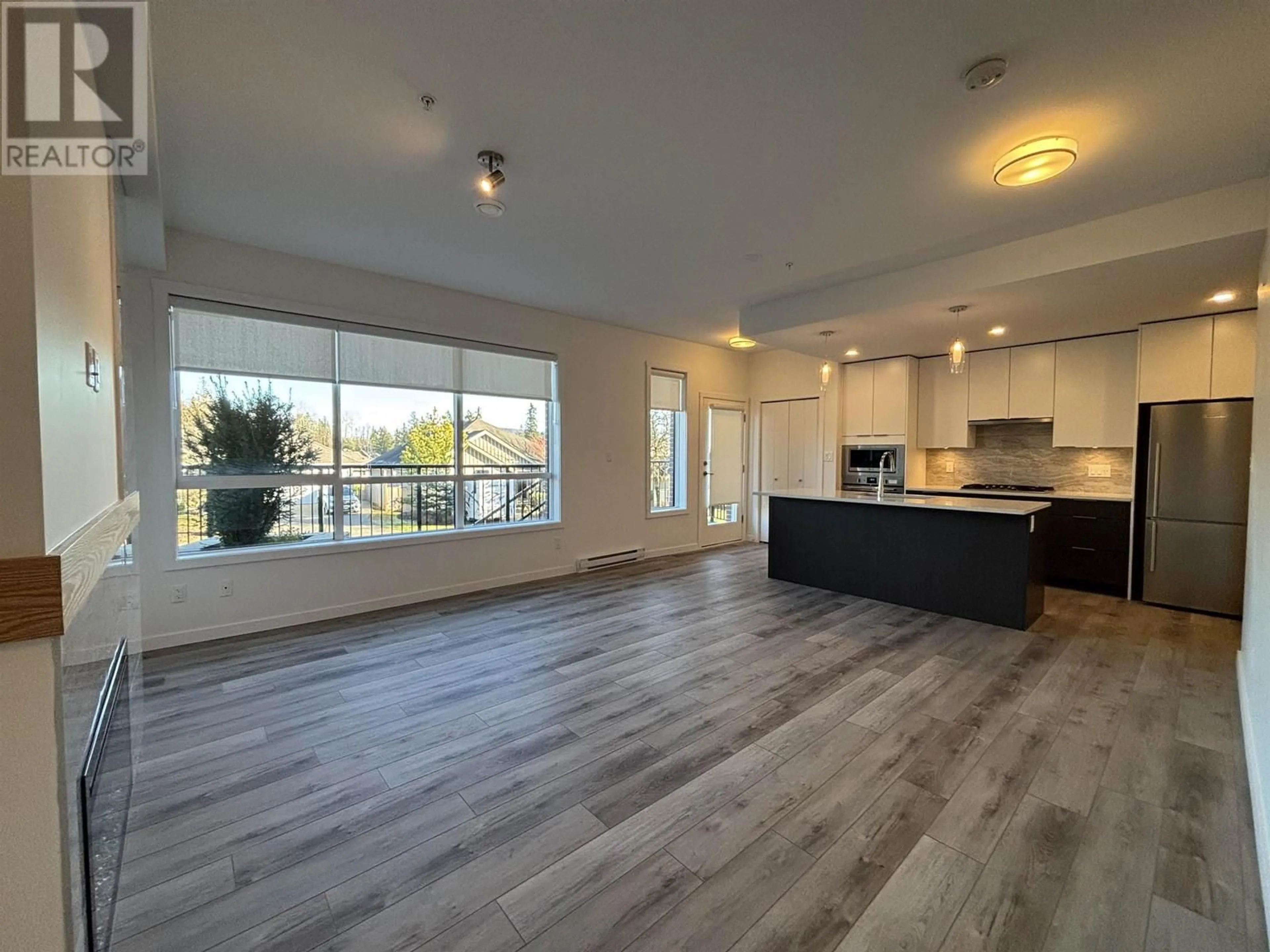 Open concept kitchen, wood/laminate floor for 104 11639 227 STREET, Maple Ridge British Columbia V2X9J6