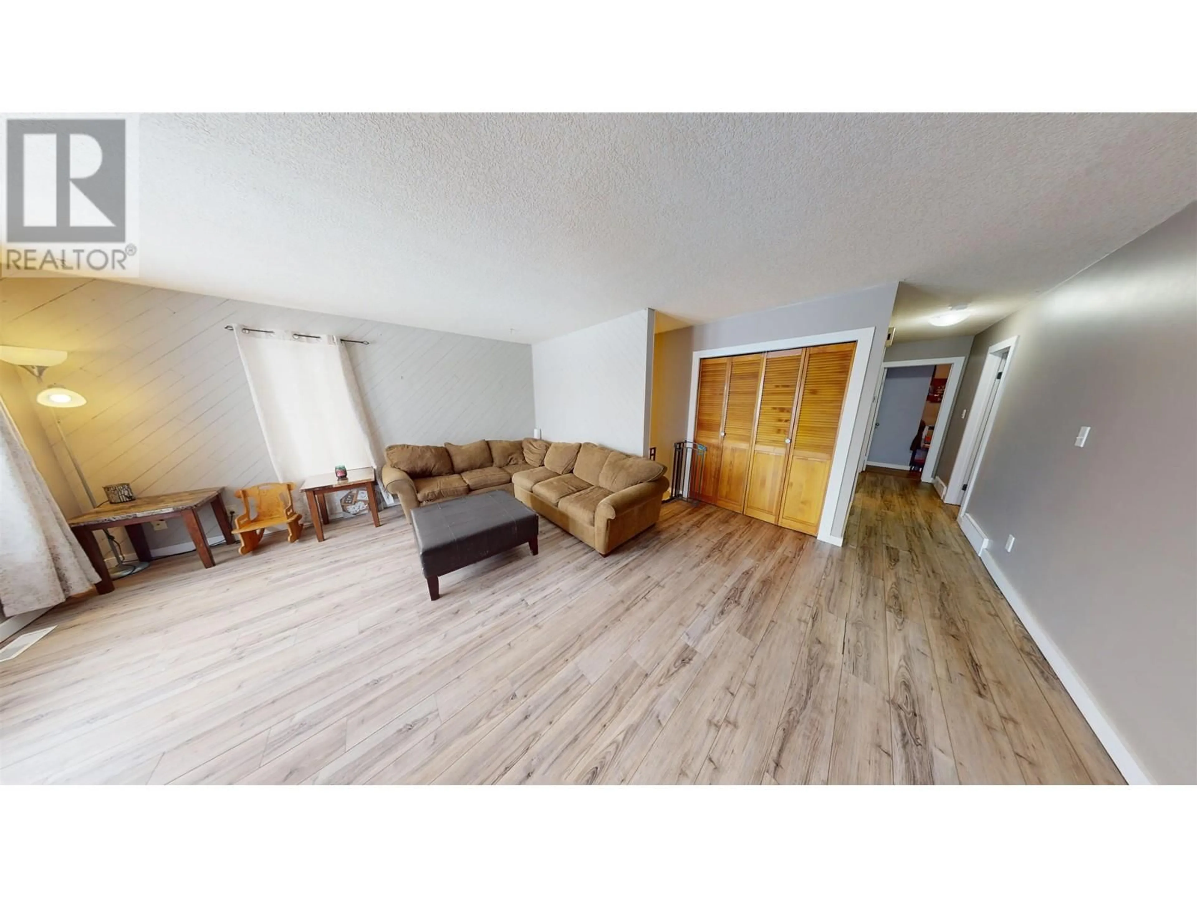 Living room with furniture, wood/laminate floor for 10520 88A STREET, Fort St. John British Columbia V1J5X9