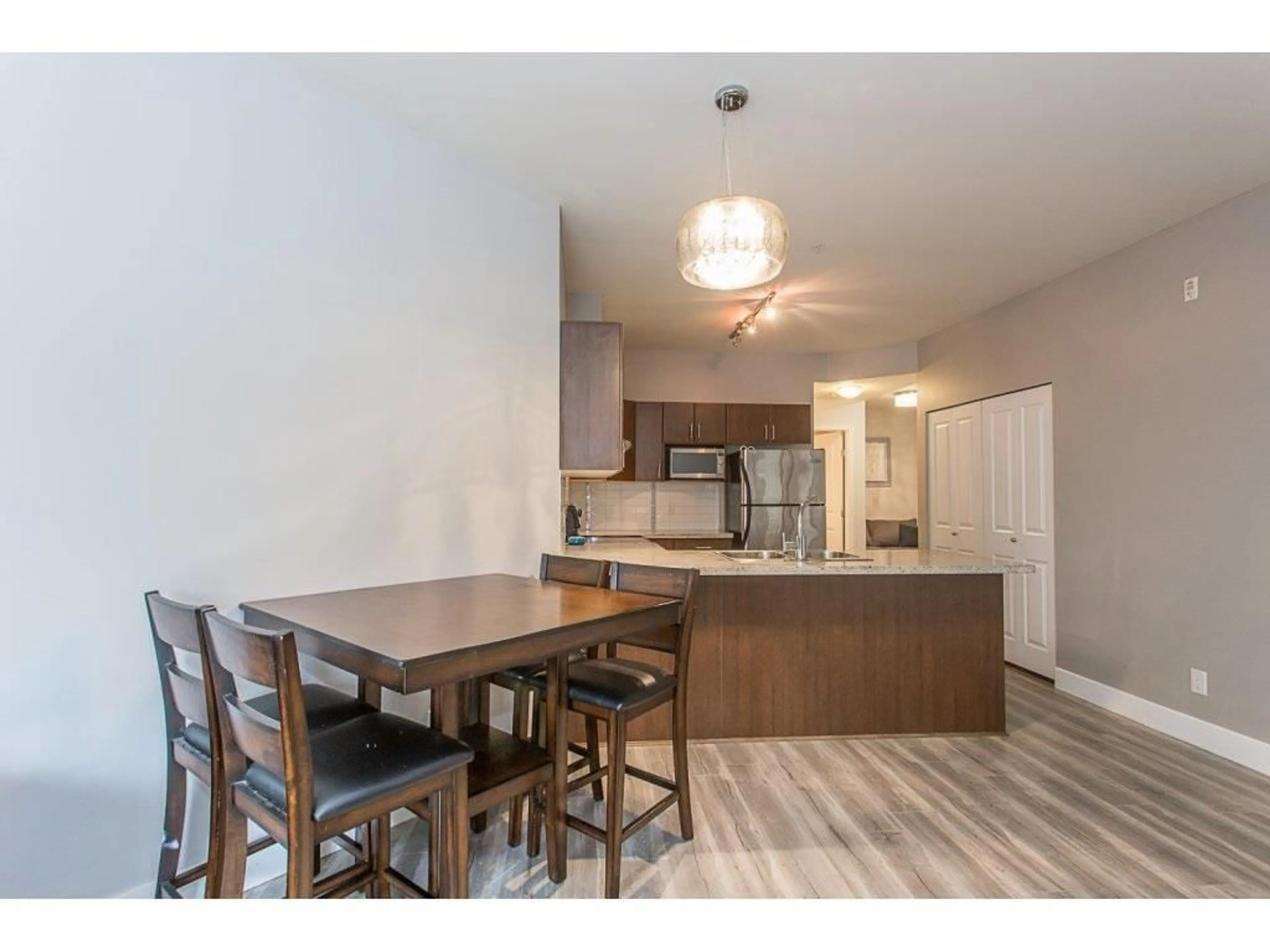 Open concept kitchen, wood/laminate floor for 109 19830 56 AVENUE, Langley British Columbia V3A0A5