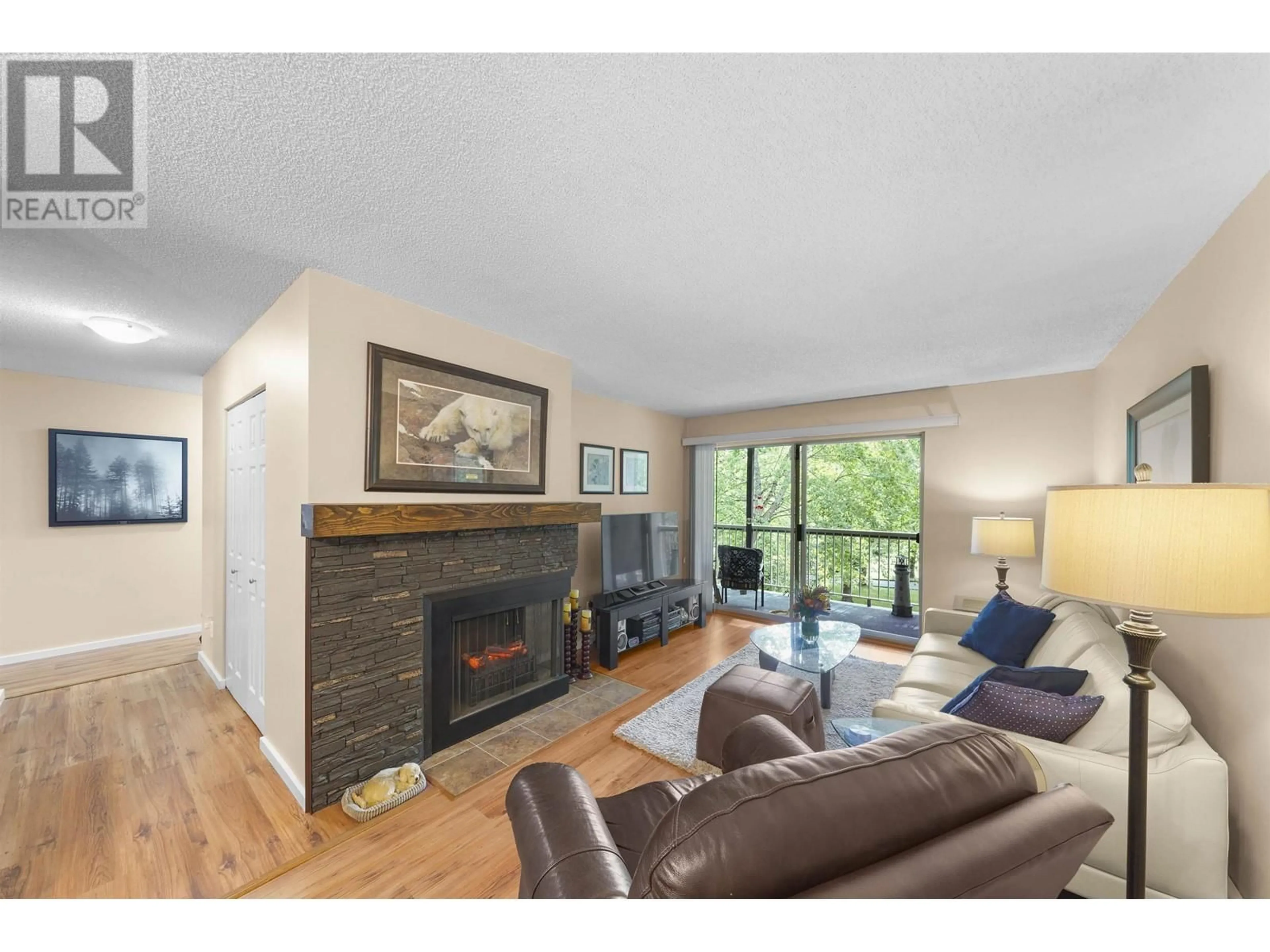 Living room with furniture, wood/laminate floor for 310 10631 NO. 3 ROAD, Richmond British Columbia V7A4L8